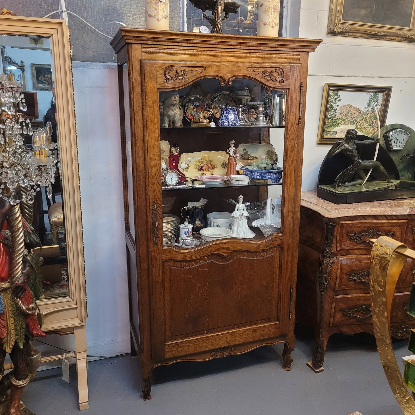 French Oak Louis XV Style Vitrine with two fixed glass shelves at the top and two fixed wooden shelves at the base for added storage. It has been sourced from France and in good original detailed condition.