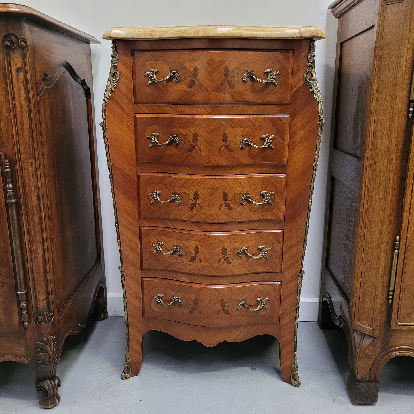 Stunning chest of five drawers with a marble top and decorative marquetry inlay. From circa 1930's this pieces has been fully restored.