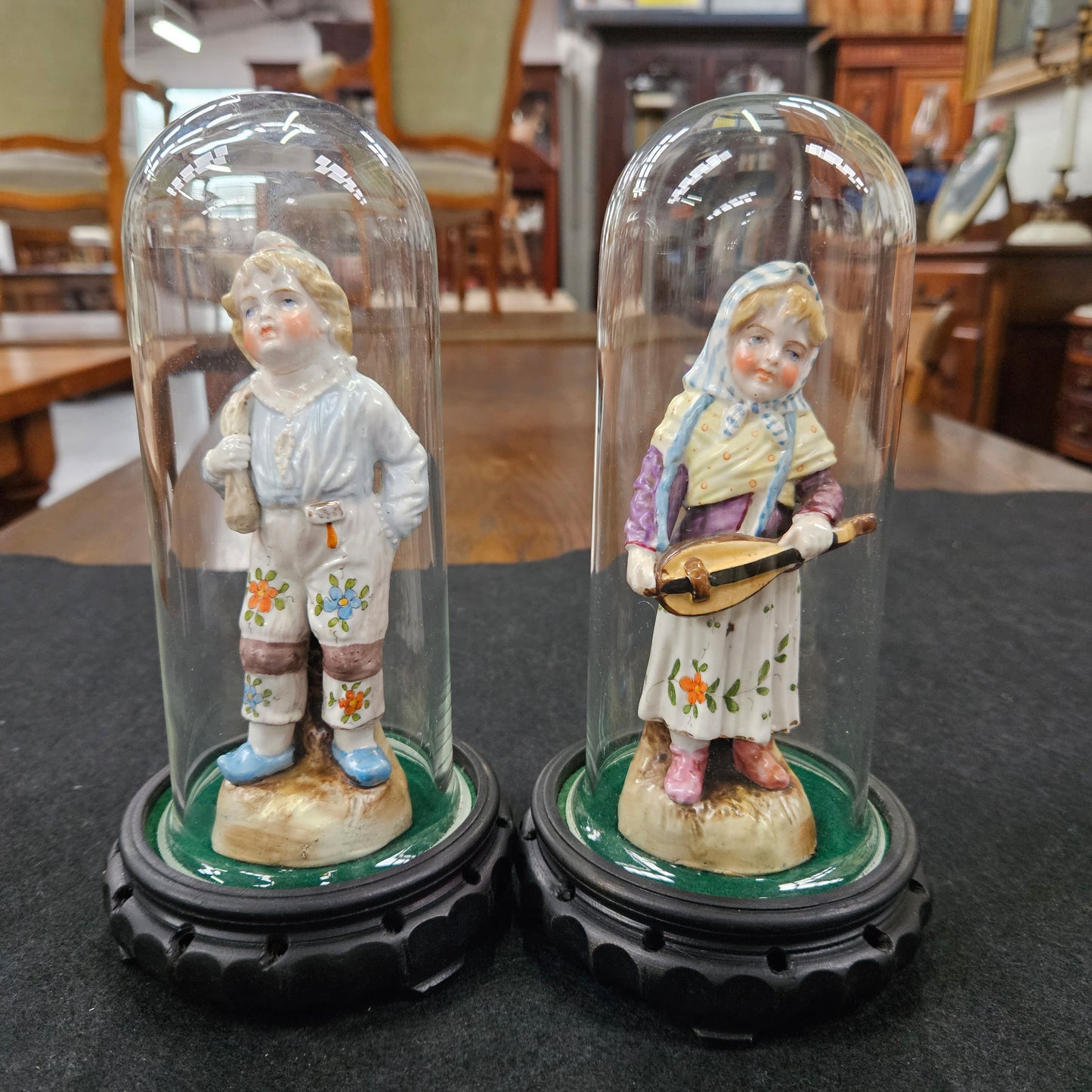 Pair Late Victorian Austrian figures displayed in glass domes