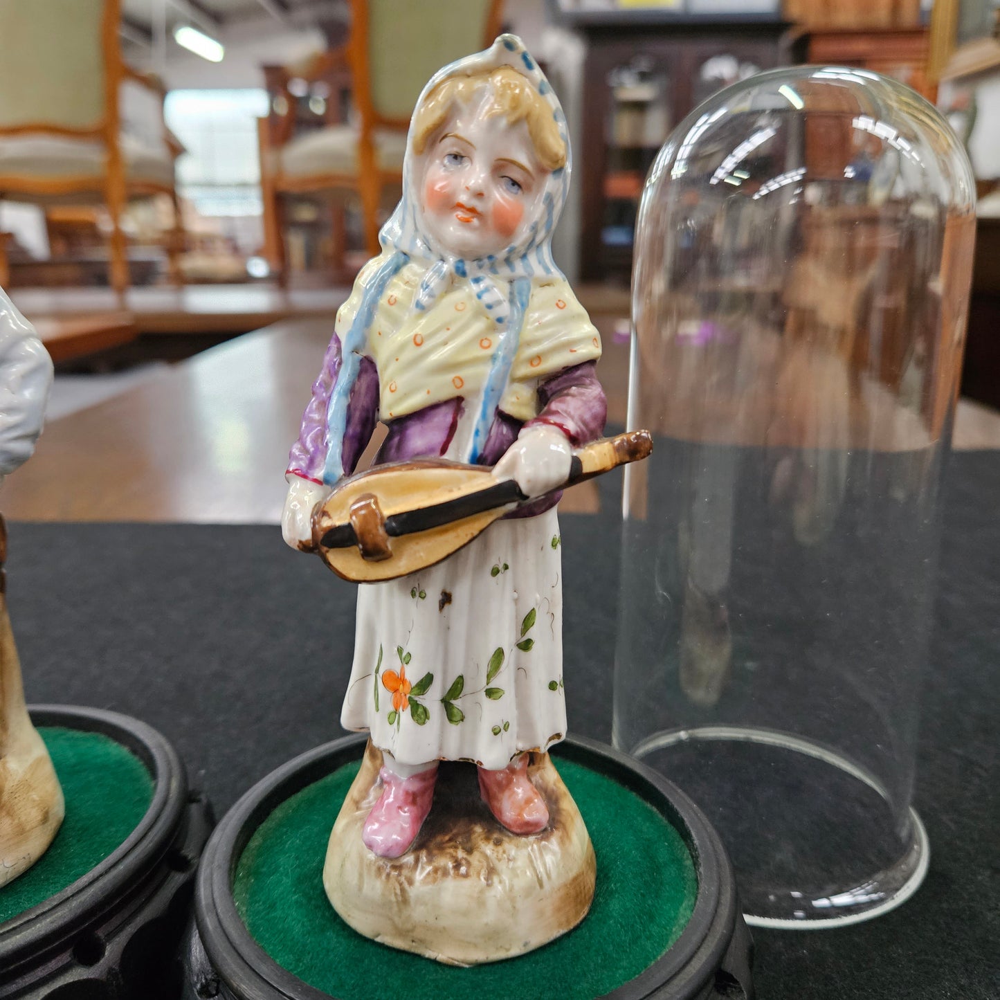 Pair Late Victorian Austrian figures displayed in glass domes