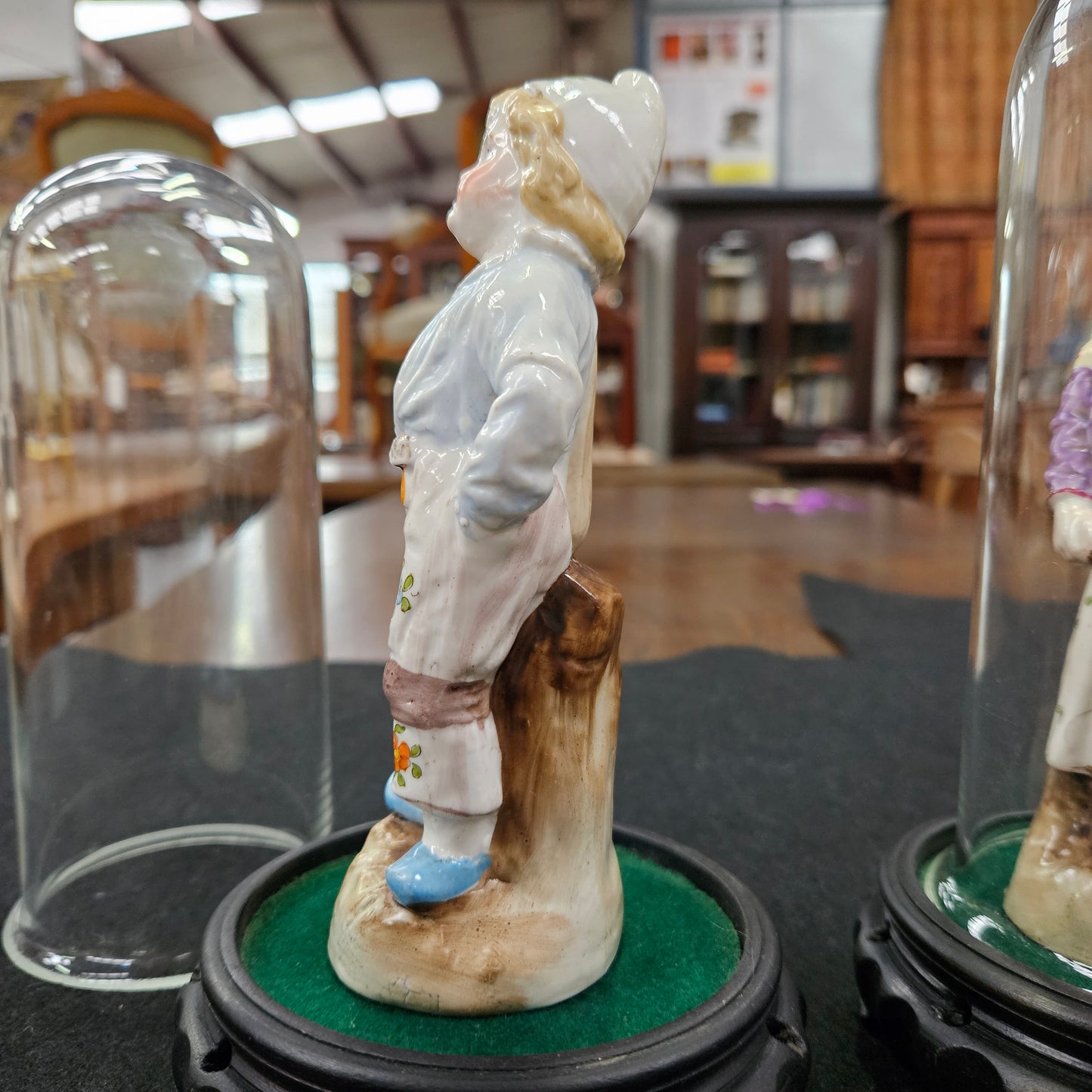 Pair Late Victorian Austrian figures displayed in glass domes