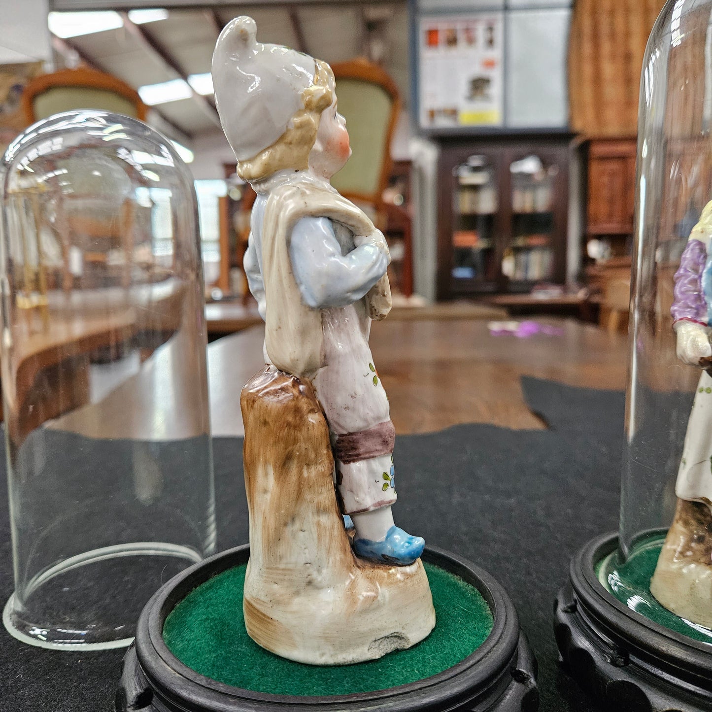 Pair Late Victorian Austrian figures displayed in glass domes
