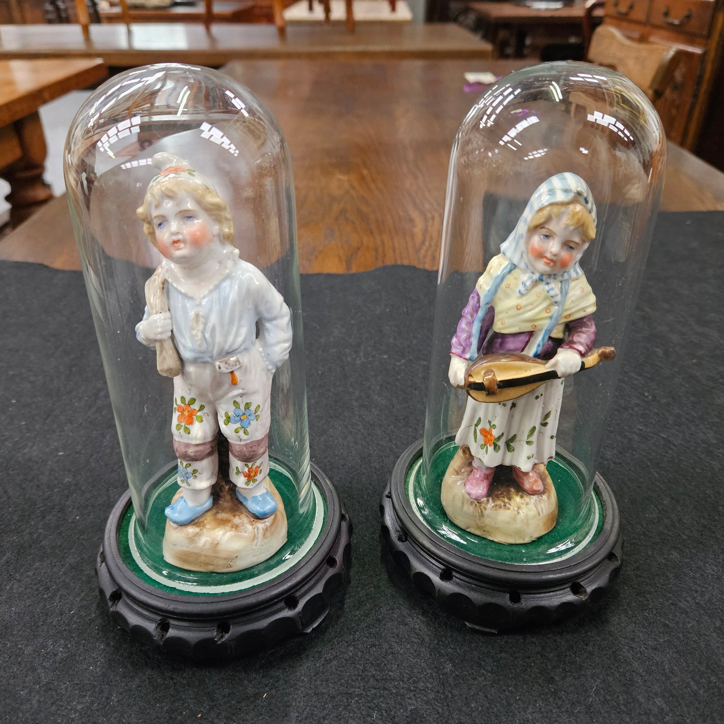 Pair Late Victorian Austrian figures displayed in glass domes