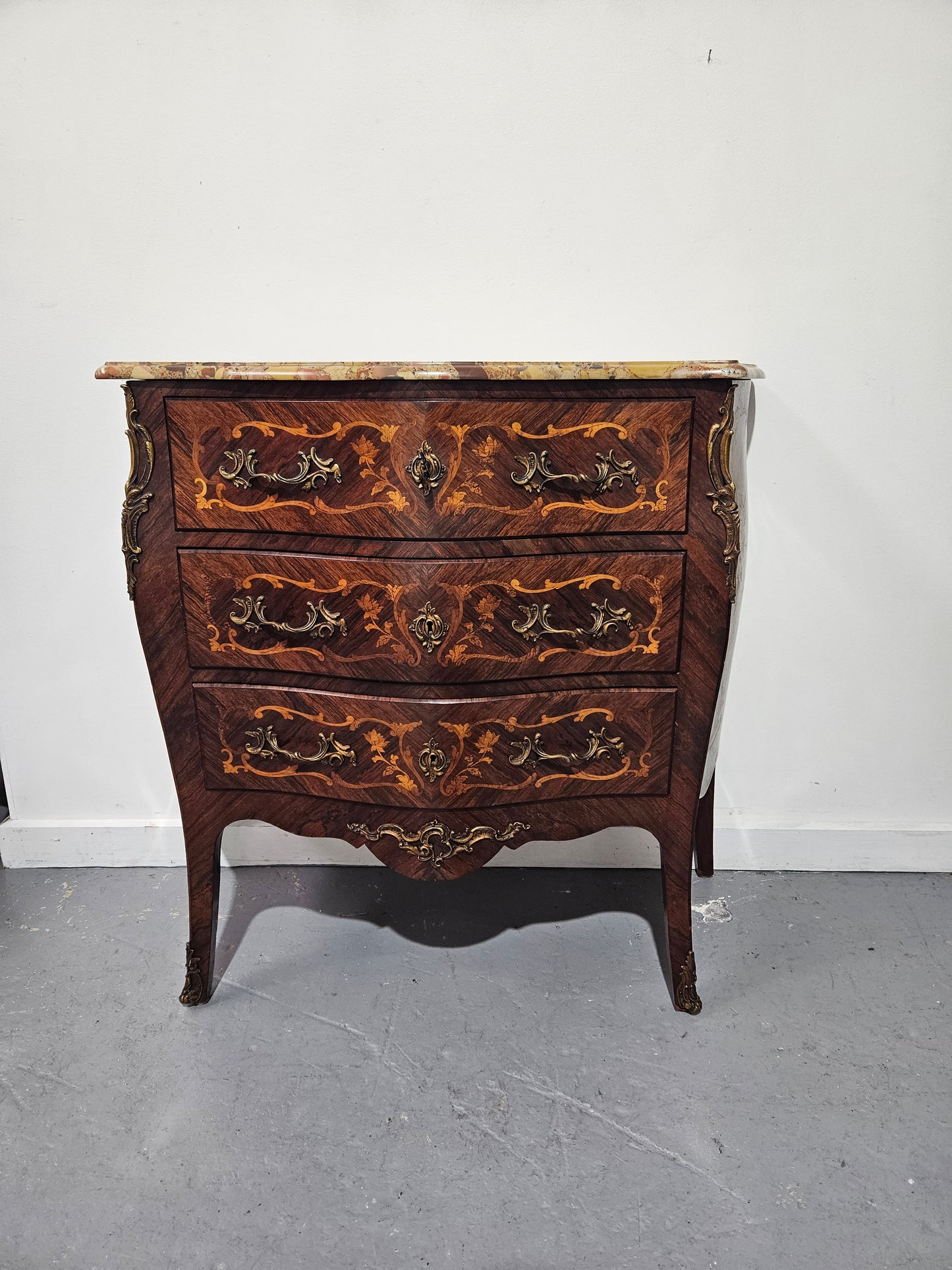Stunning Antique rosewood three drawer marquetry inlaid marble top commode with ormolu mounts. It is in great original detailed condition. Please see photos as they form part of the description.