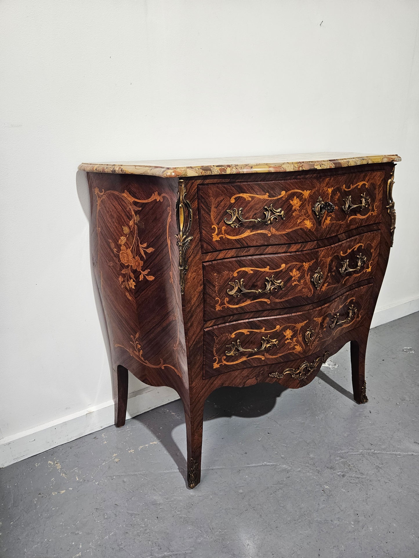 Stunning Antique rosewood three drawer marquetry inlaid marble top commode with ormolu mounts. It is in great original detailed condition. Please see photos as they form part of the description.