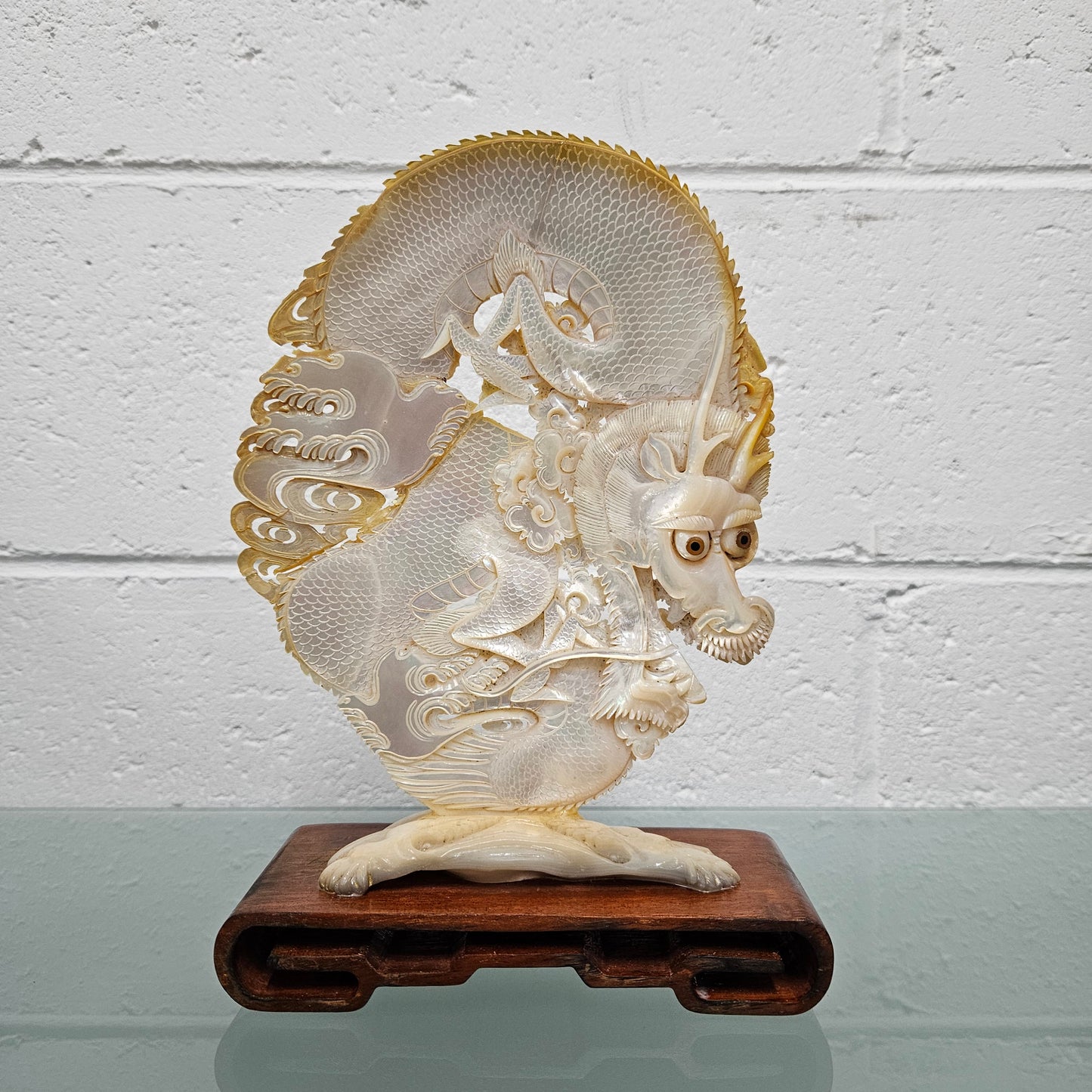 Stunning Dragon Carving on Mother of Pearl. Mounted on Wooden Stand. Please see photos as they form part of the description.
