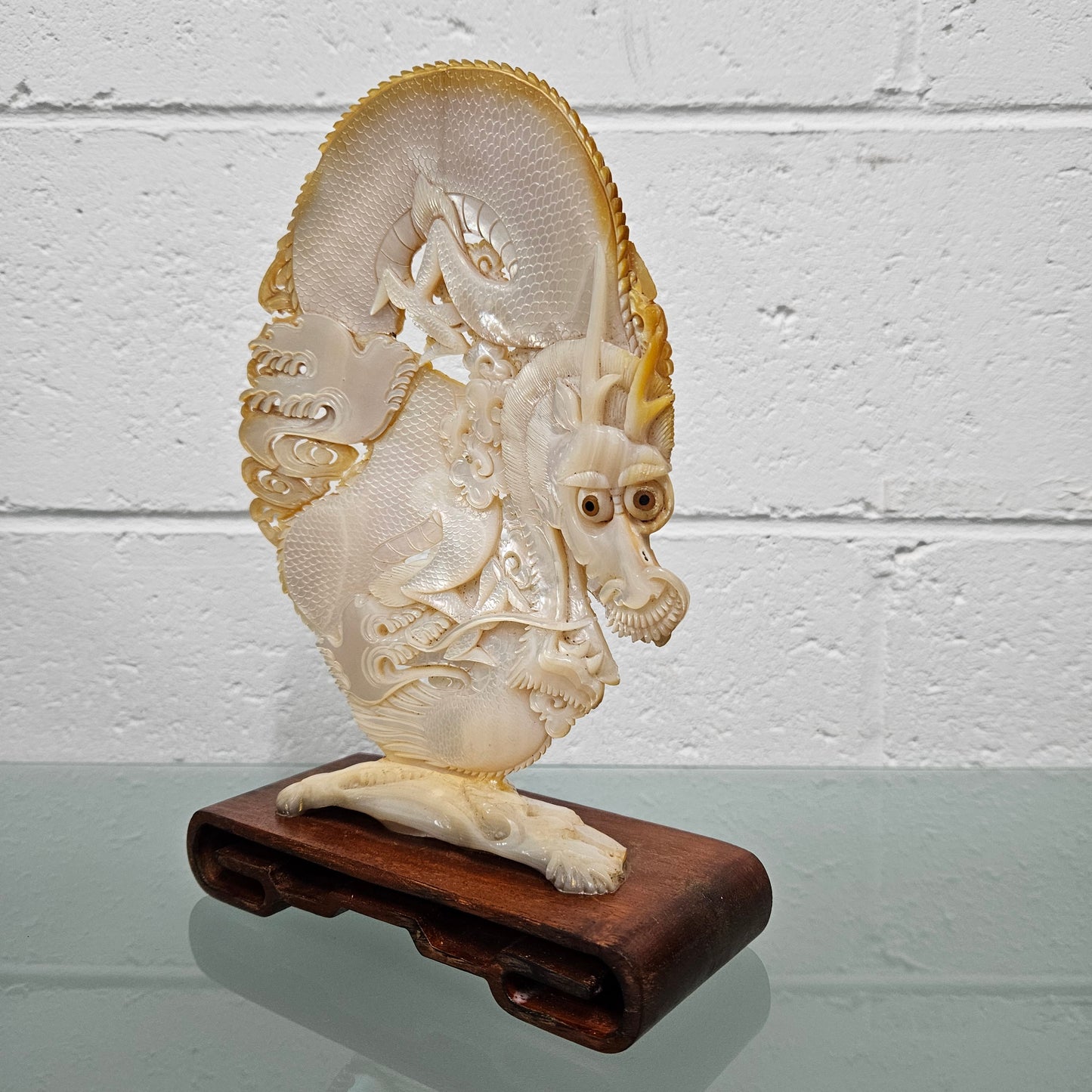 Stunning Dragon Carving on Mother of Pearl. Mounted on Wooden Stand. Please see photos as they form part of the description.