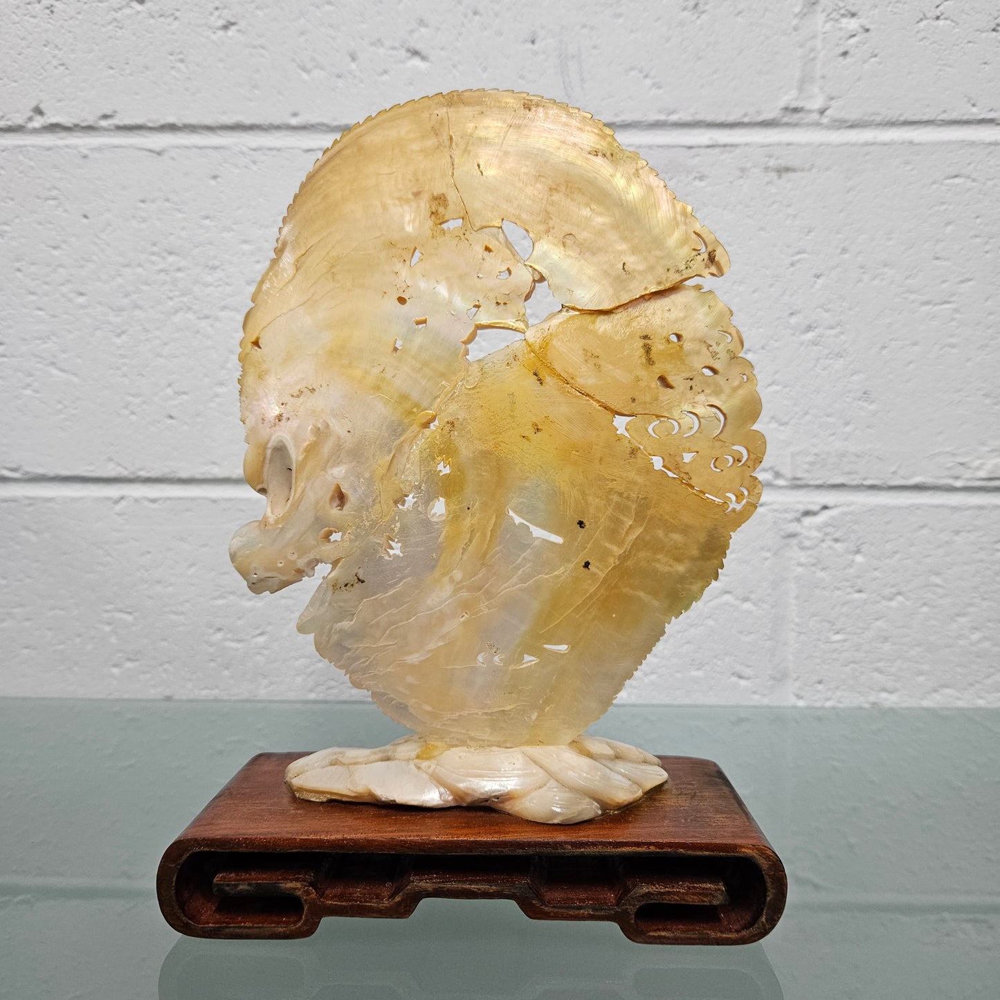 Stunning Dragon Carving on Mother of Pearl. Mounted on Wooden Stand. Please see photos as they form part of the description.
