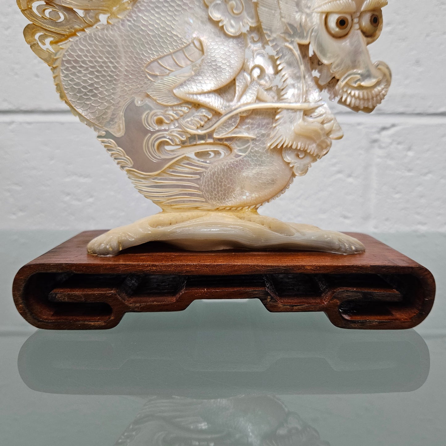 Stunning Dragon Carving on Mother of Pearl. Mounted on Wooden Stand. Please see photos as they form part of the description.