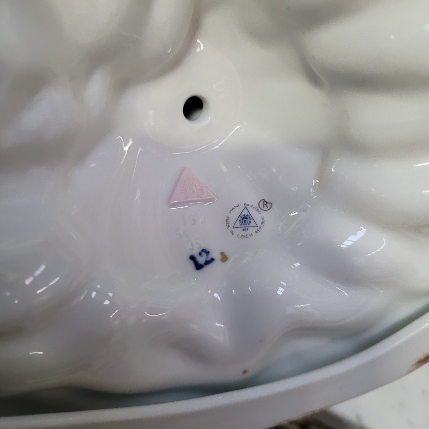 This Royal Dux Bohemia seated figurine of a lady is a beautiful and sophisticated piece. She is wearing a cobalt blue and white dress, and is in good original condition; please review the accompanying photos for more details.