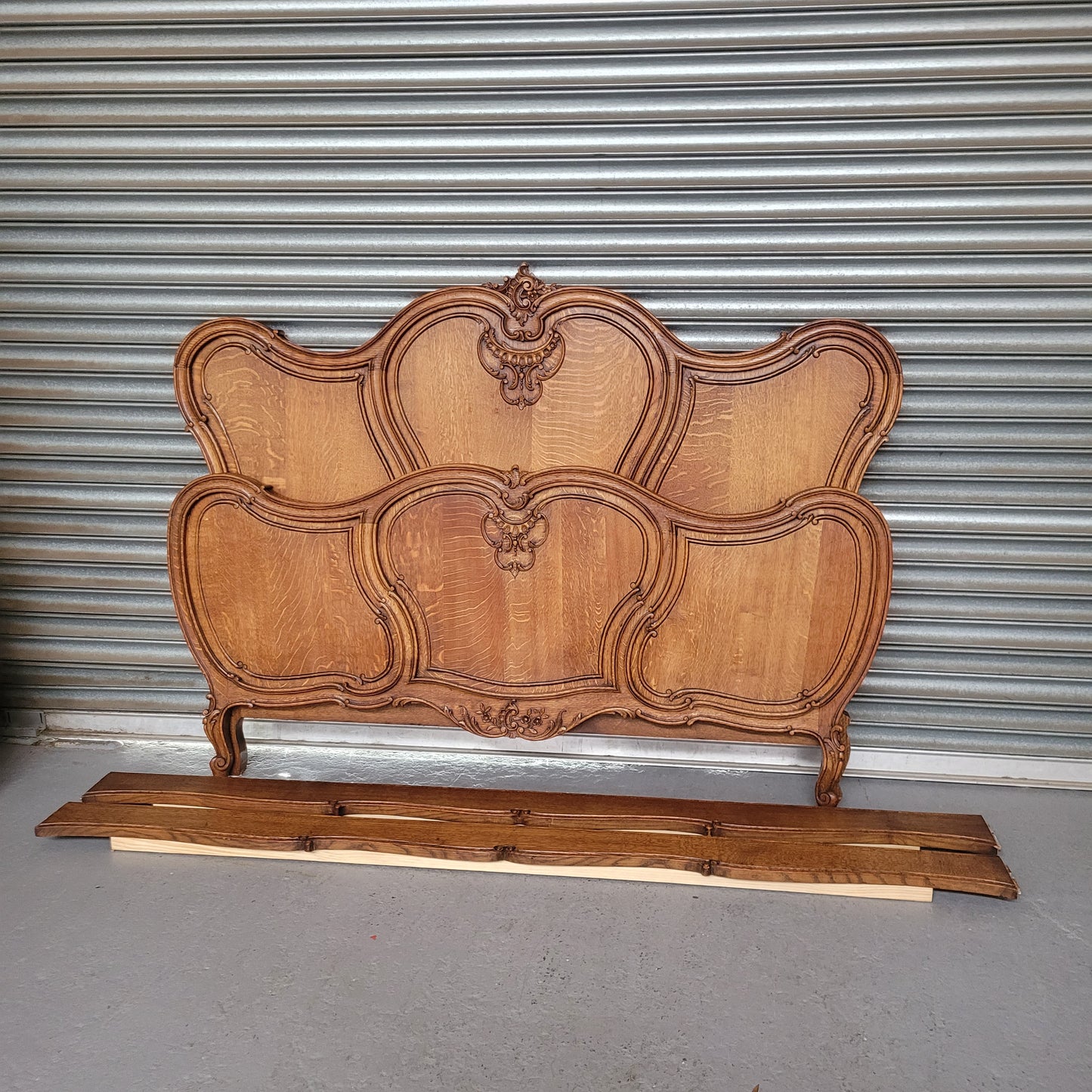 Beautifully carved French Oak Louis XV style queen size bed. It comes with beautiful carved side rails and custom made slats ready for your mattress. Sourced from France it is in good original detailed condition.