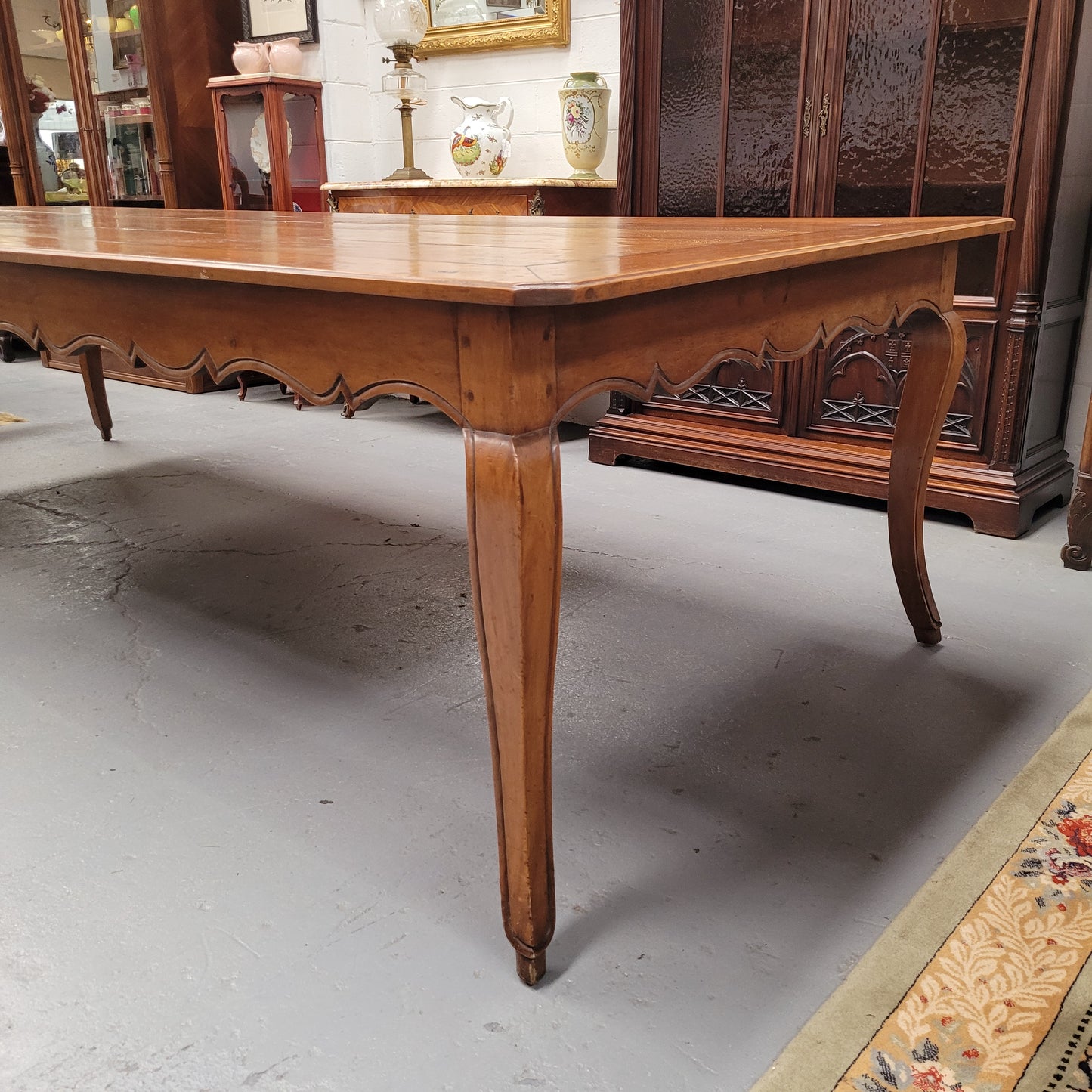Rustic 19th Century French Fruitwood Parisian farmhouse dining table. Sourced from France this amazing hard to find size table can easily sit 12 to 14 people. It is good original detailed condition. Please see photos as they form part of the descript
