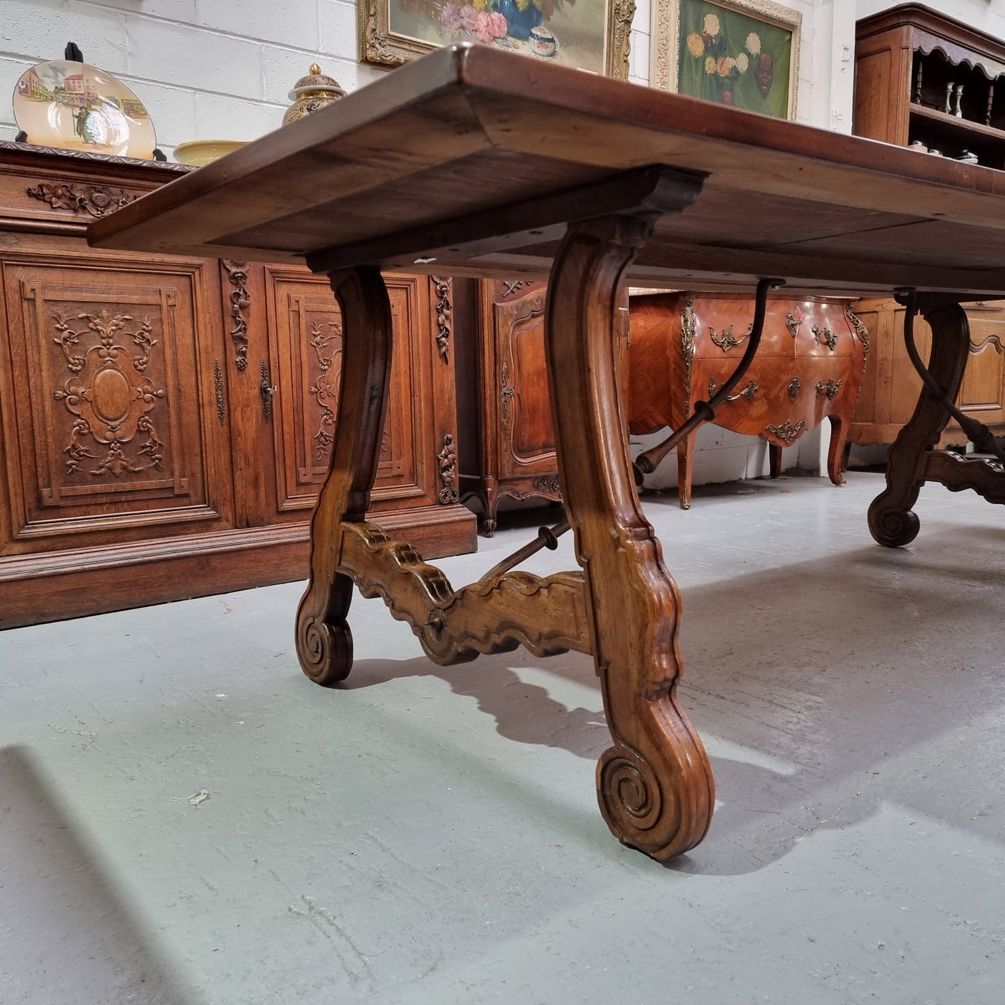 This exquisite 2.5m-long dark oak Spanish style dining table showcases exceptional ironwork underneath and is sourced from France, it is in good original detailed condition