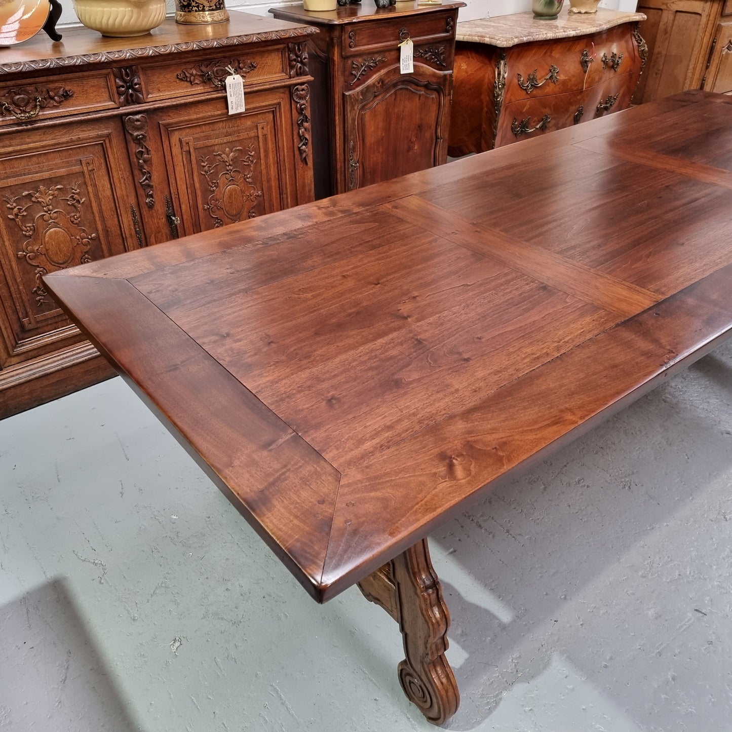 This exquisite 2.5m-long dark oak Spanish style dining table showcases exceptional ironwork underneath and is sourced from France, it is in good original detailed condition