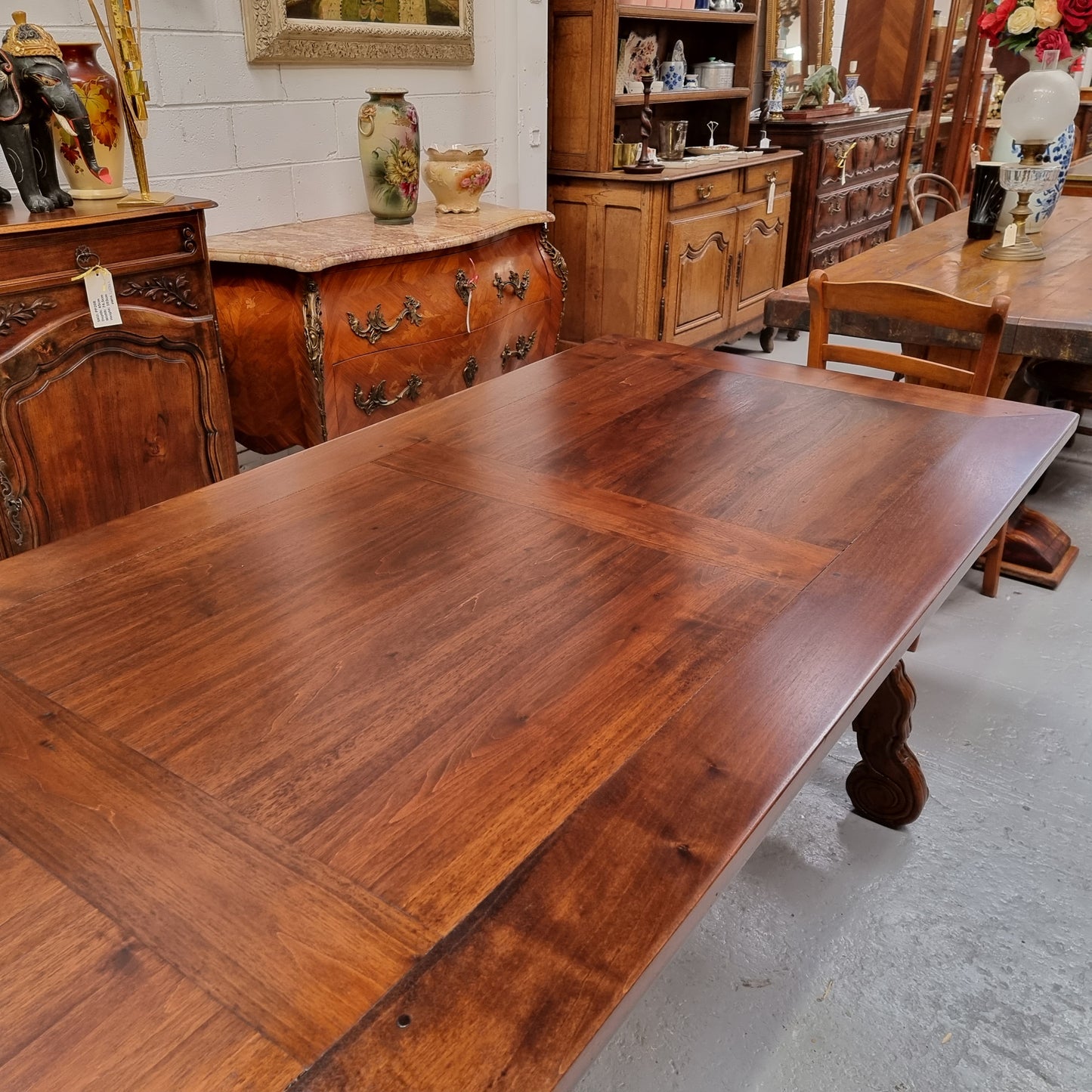 This exquisite 2.5m-long dark oak Spanish style dining table showcases exceptional ironwork underneath and is sourced from France, it is in good original detailed condition