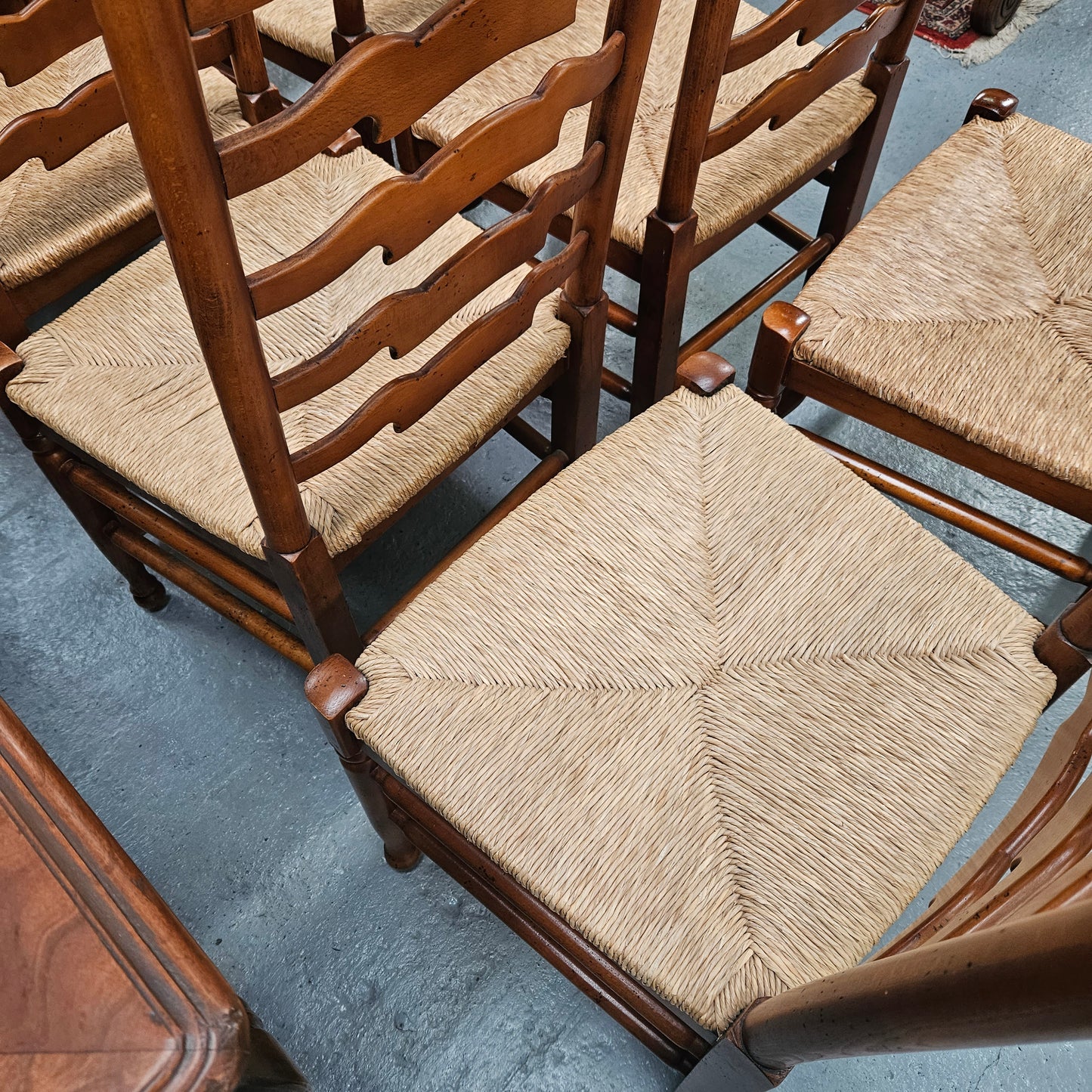 12 Beech Ladderback rush seated dining chairs. In good original detailed original condition. Please see photos as they form part of the description. Chairs sold as per each $250. Set of 12 $3,000
