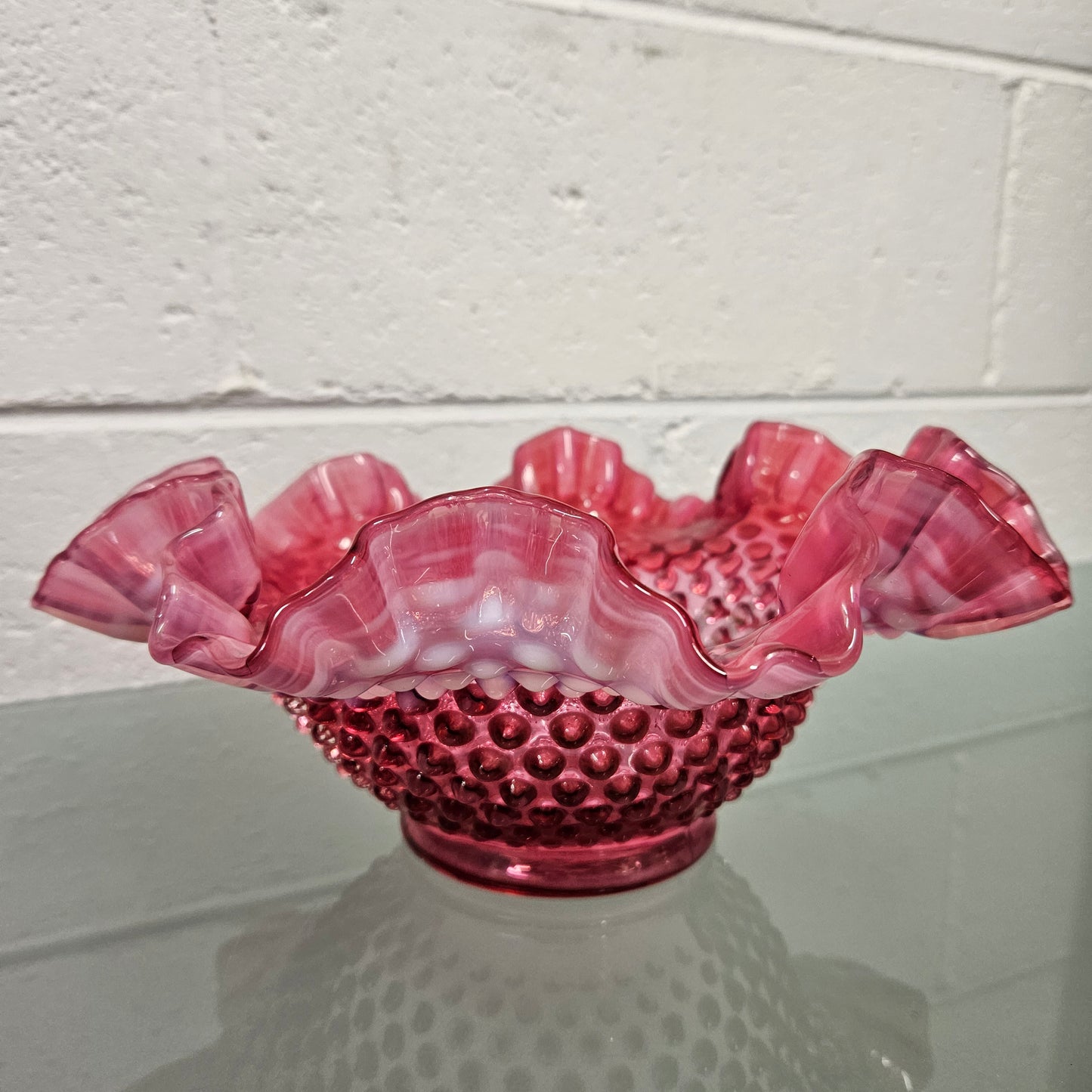 Vintage Large Fenton Cranberry glass bowl with opalescent trim. In good condition. Please see photos as they form part of the description.