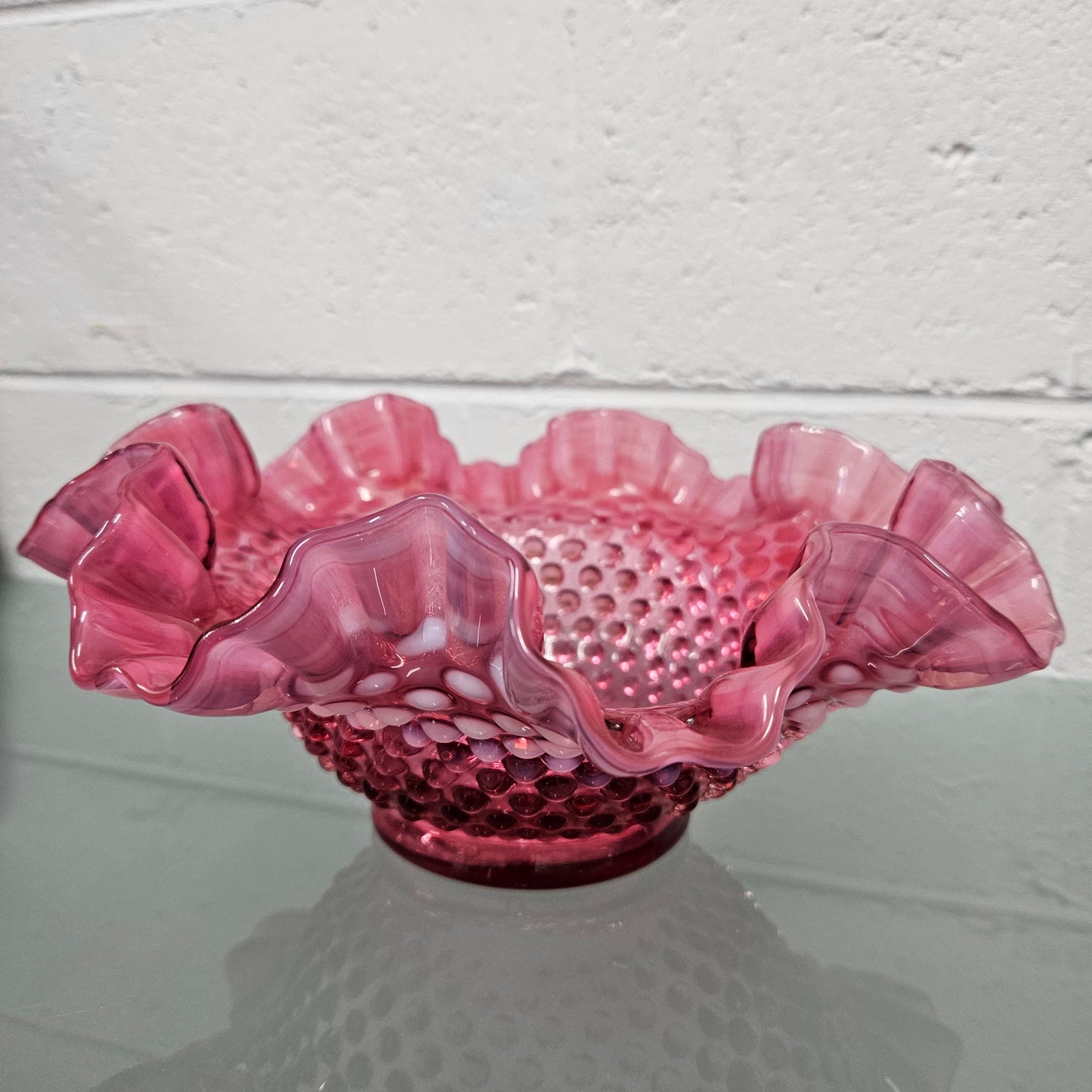 Vintage Large Fenton Cranberry glass bowl with opalescent trim. In good condition. Please see photos as they form part of the description.