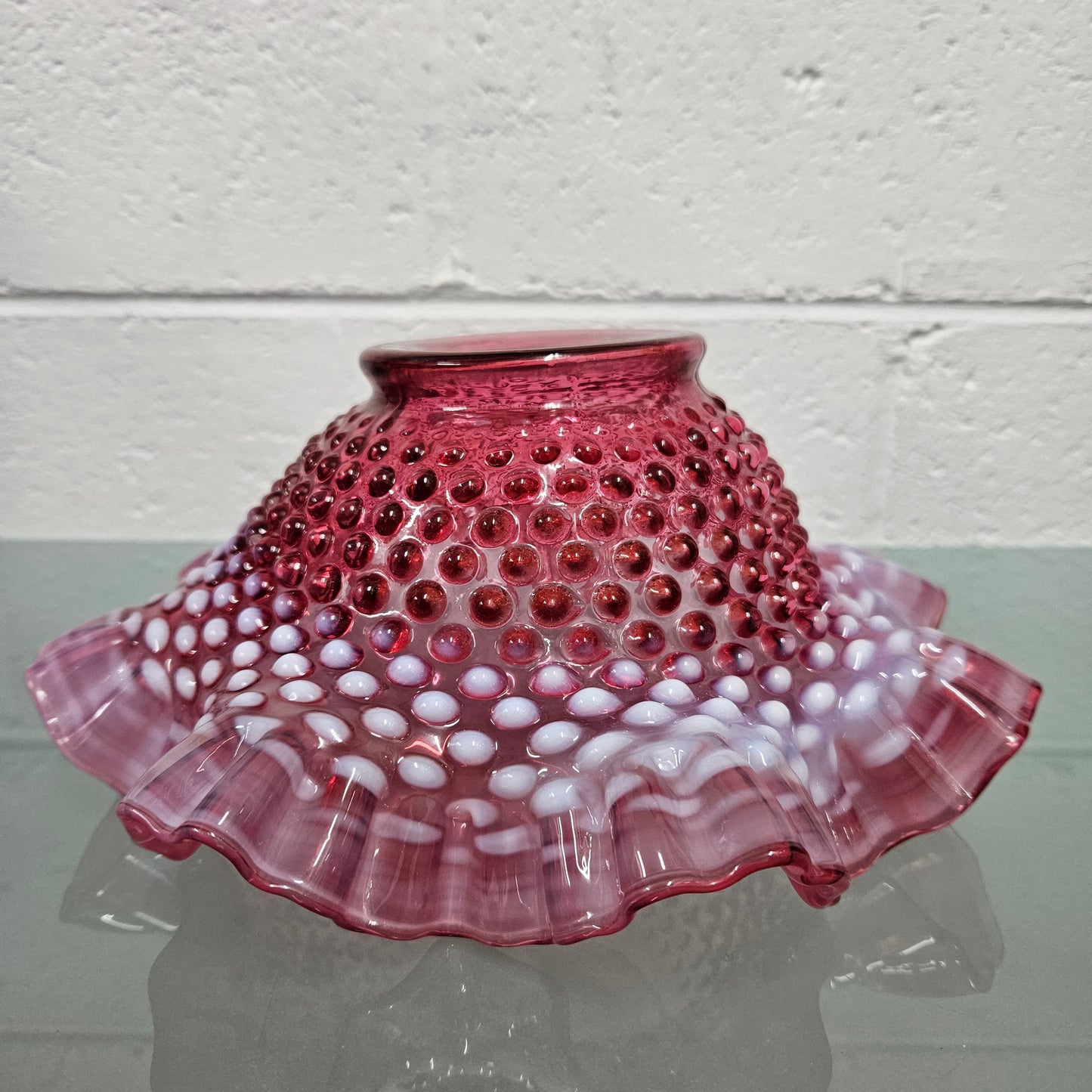 Vintage Large Fenton Cranberry glass bowl with opalescent trim. In good condition. Please see photos as they form part of the description.