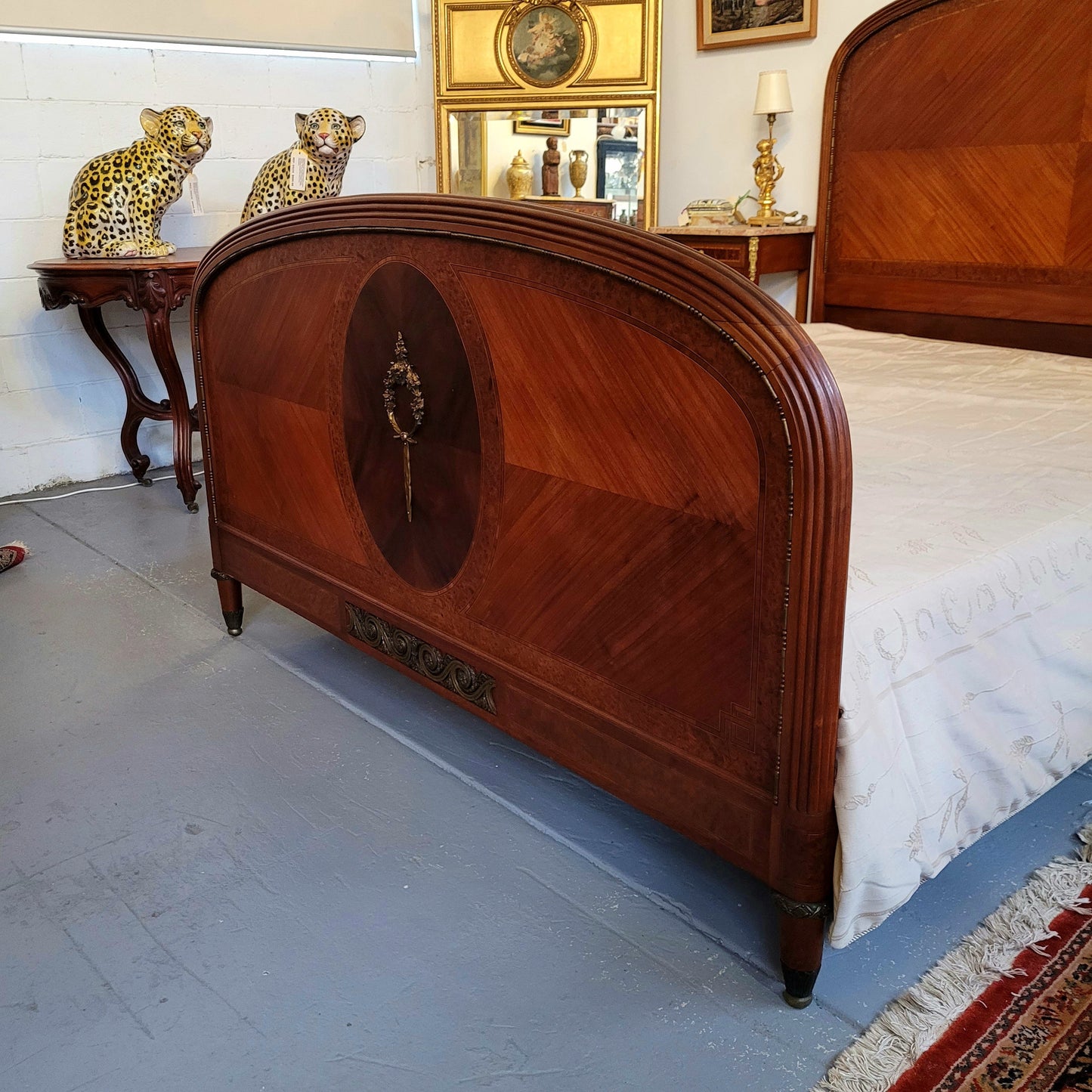 This elegant French Art Deco Walnut & Burr Walnut queen-size bed showcases stunning bronze mounts and impeccable craftsmanship. Its custom-made slats ensure a comfortable and supportive rest, while the ease of assembly and disassembly adds to its practicality. Sourced directly from France, it has been detailed and is in good condition.