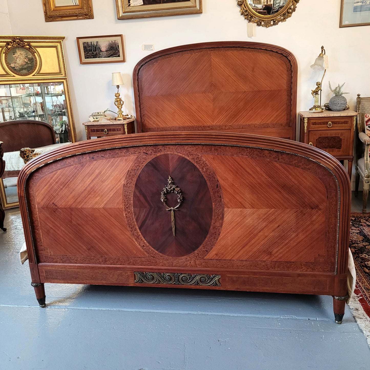 This elegant French Art Deco Walnut & Burr Walnut queen-size bed showcases stunning bronze mounts and impeccable craftsmanship. Its custom-made slats ensure a comfortable and supportive rest, while the ease of assembly and disassembly adds to its practicality. Sourced directly from France, it has been detailed and is in good condition.