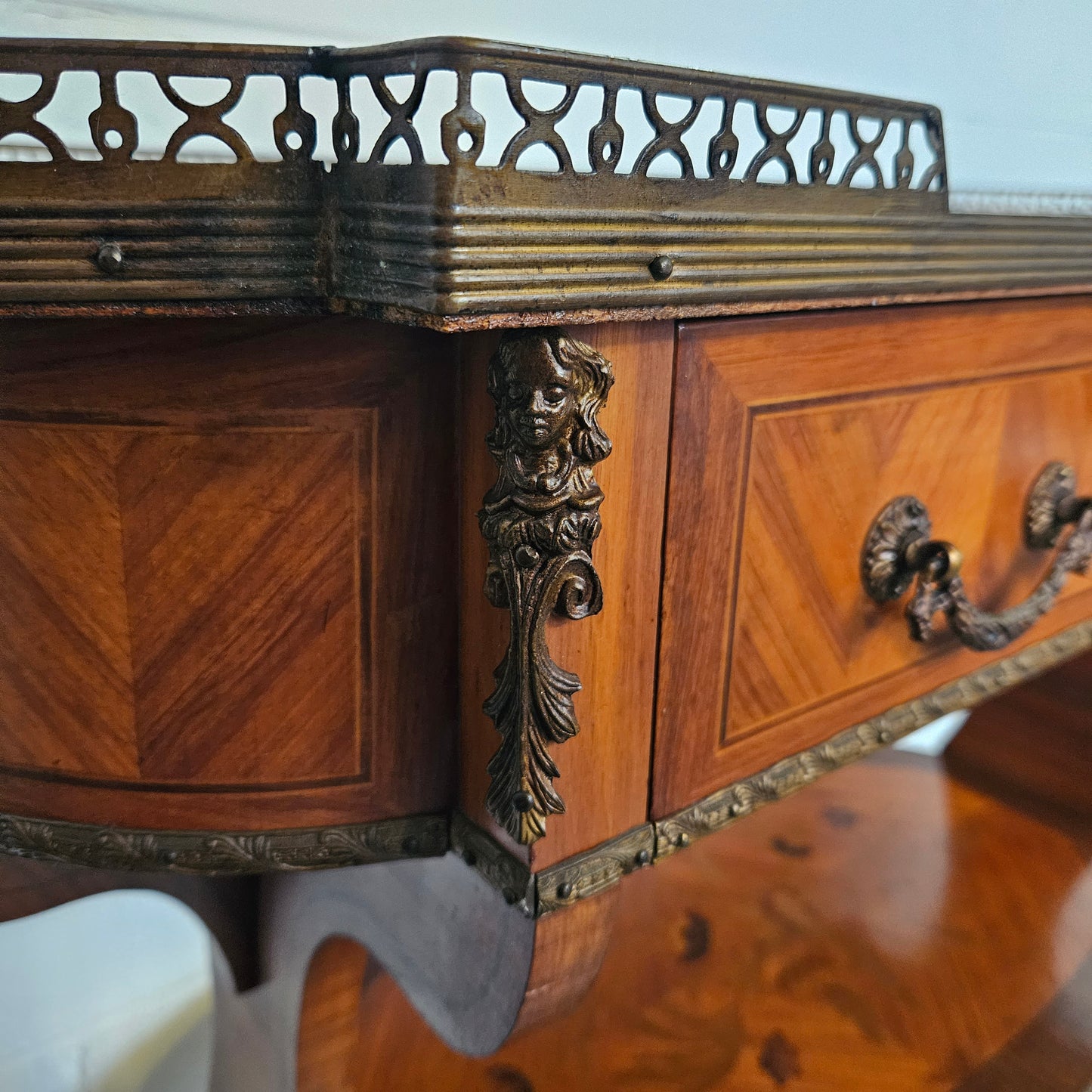 Charming mahogany & walnut marquetry inlaid 2 shelf sofa table. It has 1 drawer and a gallery to the top shelf with further ormolu trims. Sourced from France. In good condition commensurate with age.