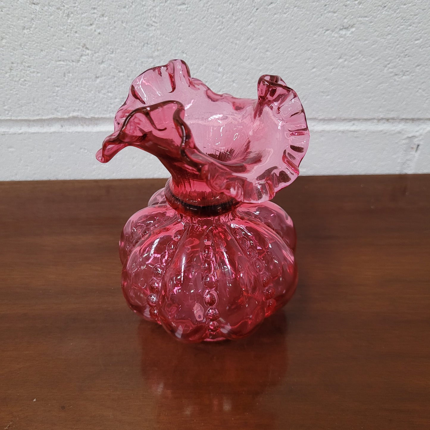 Very attractive Fenton cranberry red glass vase in the melon shape with beading between each segment and and a lovely frilled top. In excellent condition.