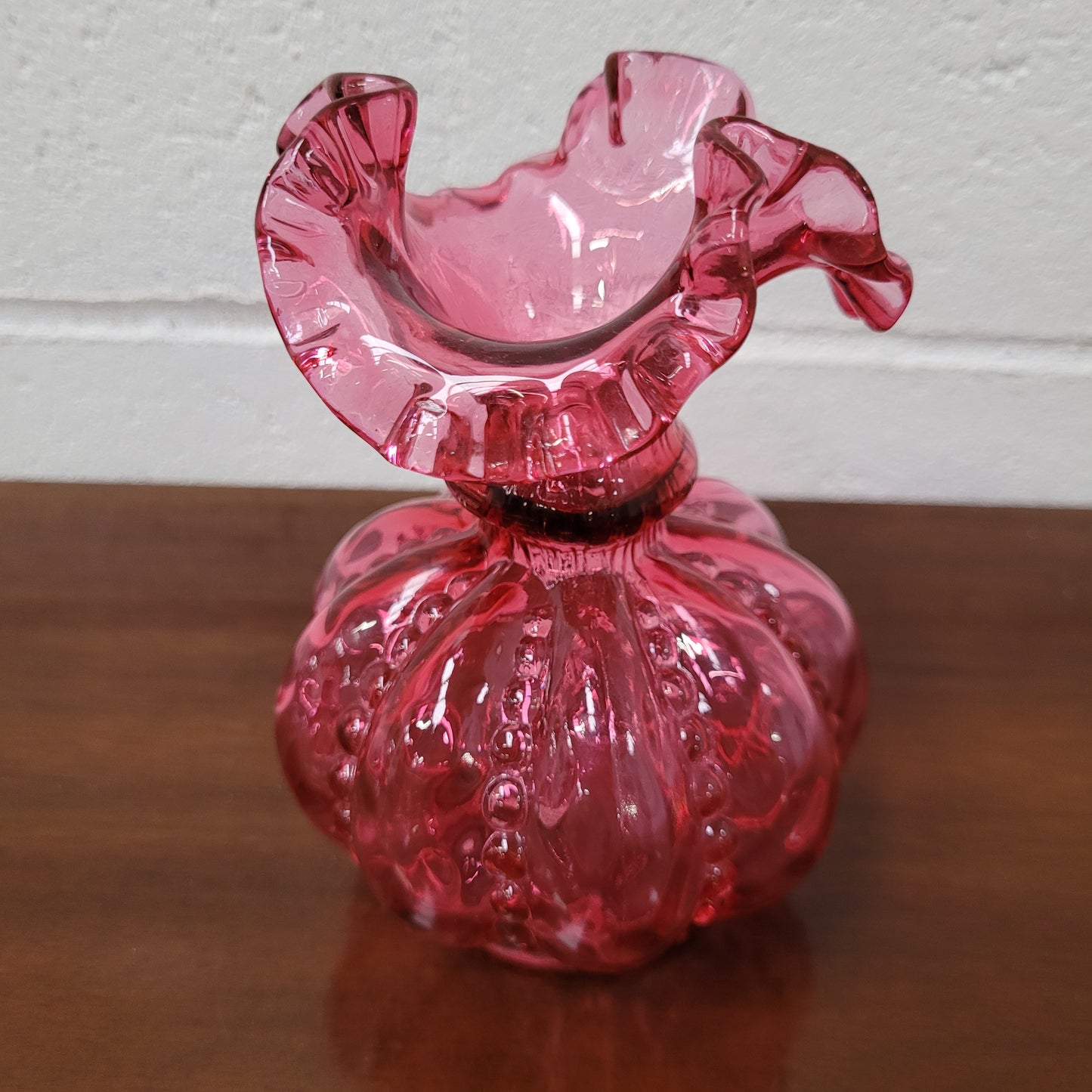 Very attractive Fenton cranberry red glass vase in the melon shape with beading between each segment and and a lovely frilled top. In excellent condition.