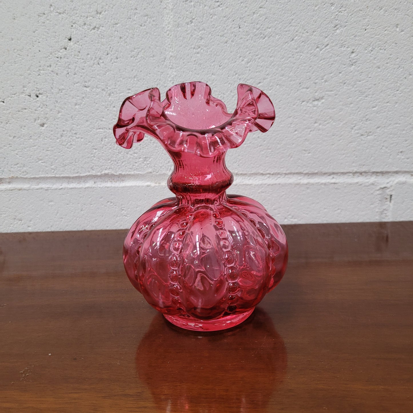 Very attractive Fenton cranberry red glass vase in the melon shape with beading between each segment and and a lovely frilled top. In excellent condition.