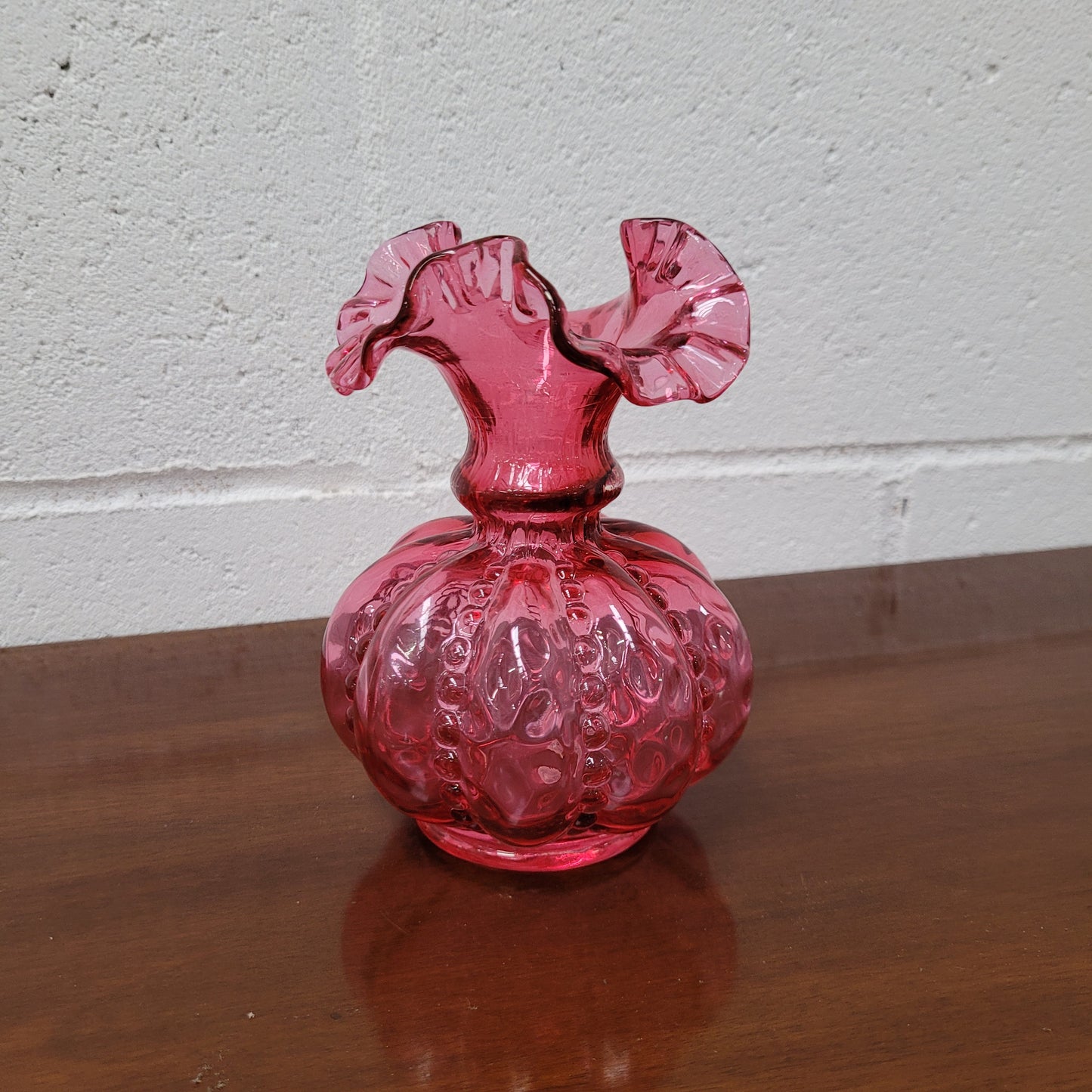 Very attractive Fenton cranberry red glass vase in the melon shape with beading between each segment and and a lovely frilled top. In excellent condition.