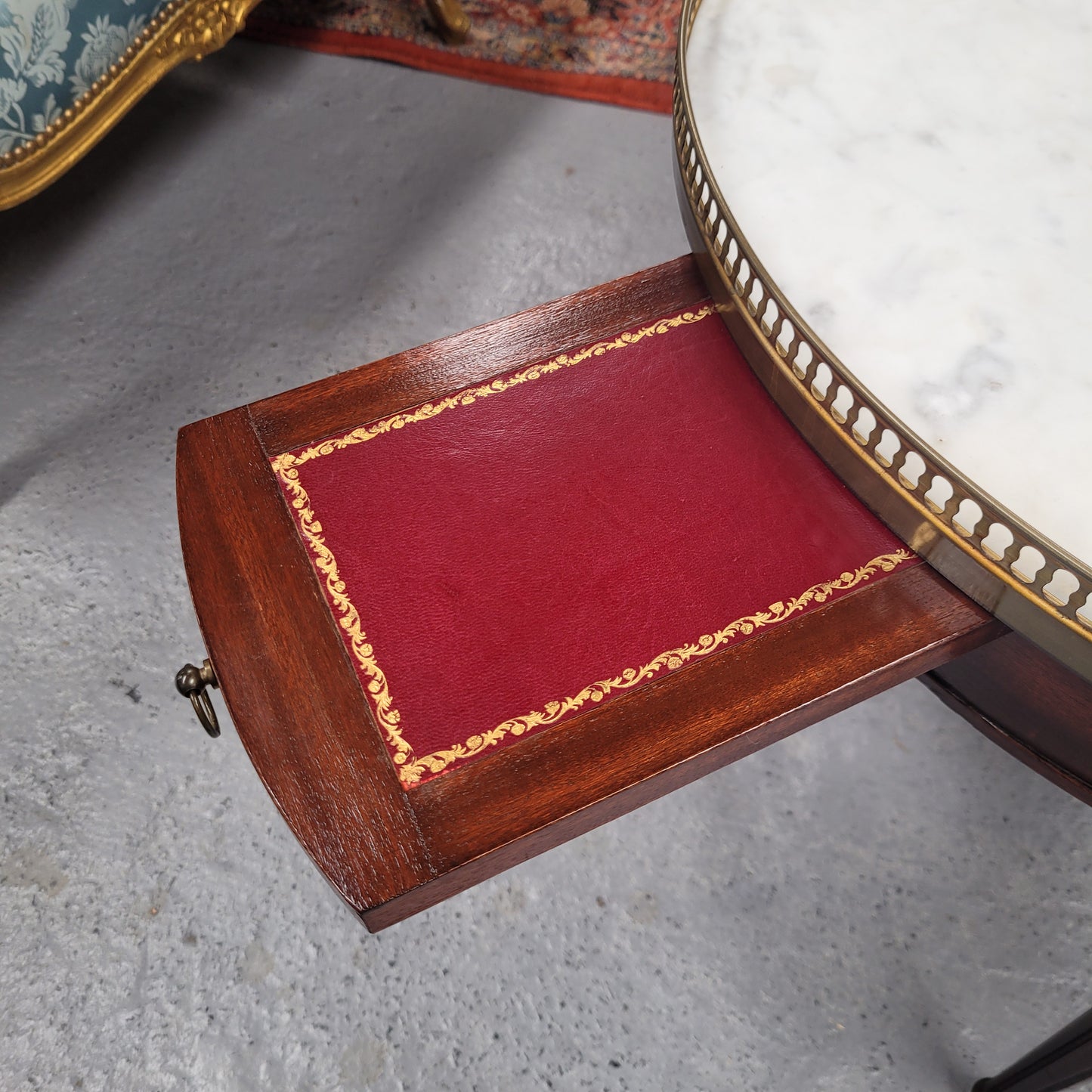 French Louis XVI style Mahogany Bouillotte table, featuring original white Carrara marble top finished nicely with a gilt brass gallery and standing on elegant tapered and fluted legs. It consists of two drawers and two slide-out extensions with leather inserts. Sourced from France and in good original detailed condition. Circa 1930.