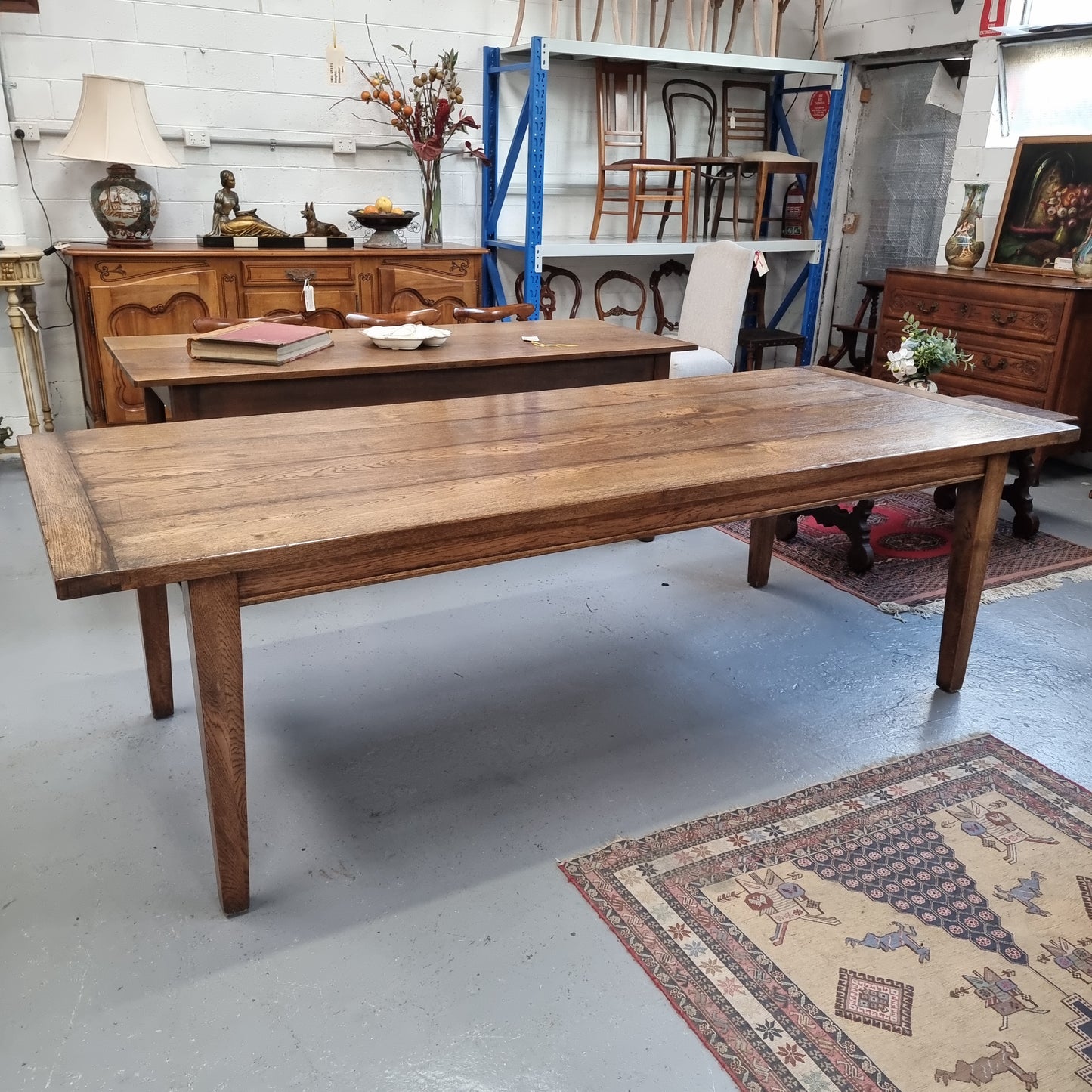 Vintage reclaimed French Oak farmhouse style dining table. It is 1 meter wide and 2.5 meters long this charming table comfortably seats 10. Made from thick Oak timber planks, It is in good original detailed condition.