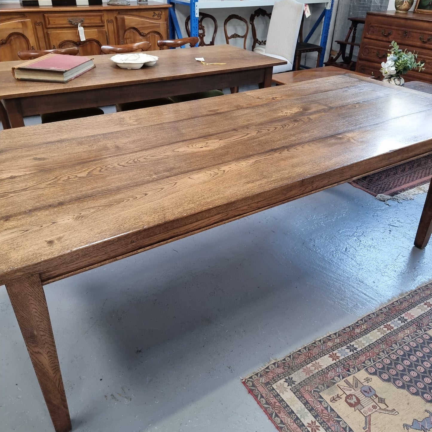 Vintage reclaimed French Oak farmhouse style dining table. It is 1 meter wide and 2.5 meters long this charming table comfortably seats 10. Made from thick Oak timber planks, It is in good original detailed condition.