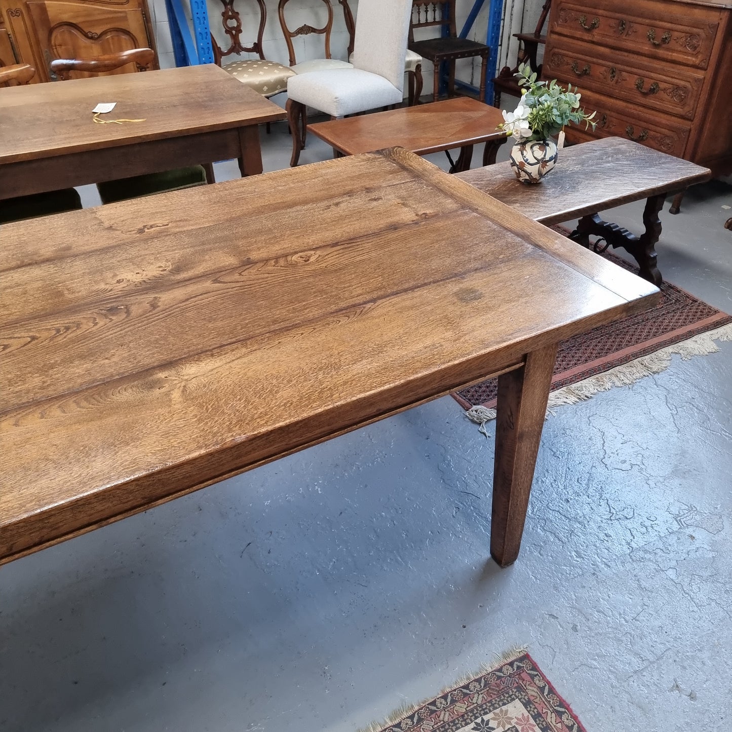 Vintage reclaimed French Oak farmhouse style dining table. It is 1 meter wide and 2.5 meters long this charming table comfortably seats 10. Made from thick Oak timber planks, It is in good original detailed condition.