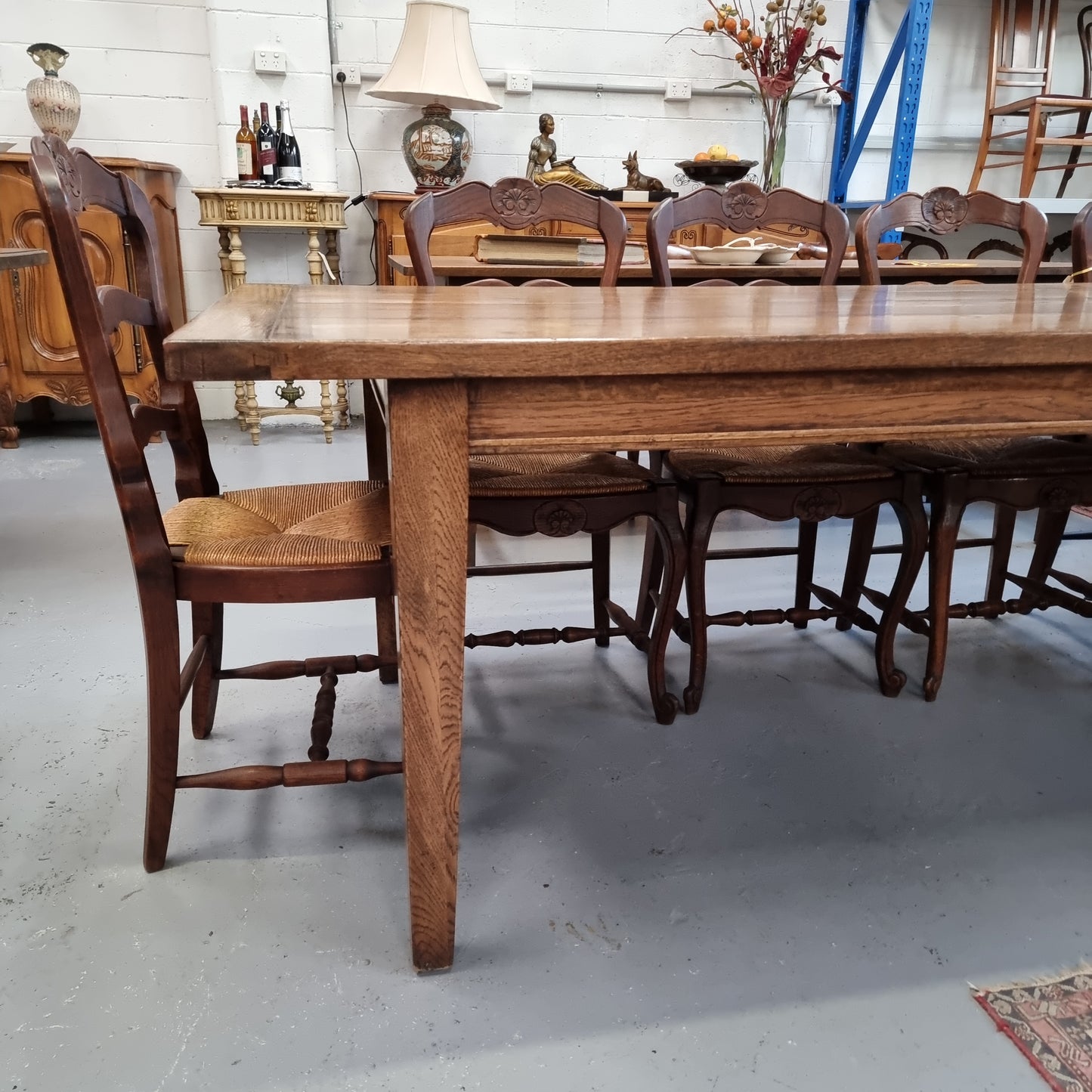 Vintage reclaimed French Oak farmhouse style dining table. It is 1 meter wide and 2.5 meters long this charming table comfortably seats 10. Made from thick Oak timber planks, It is in good original detailed condition.