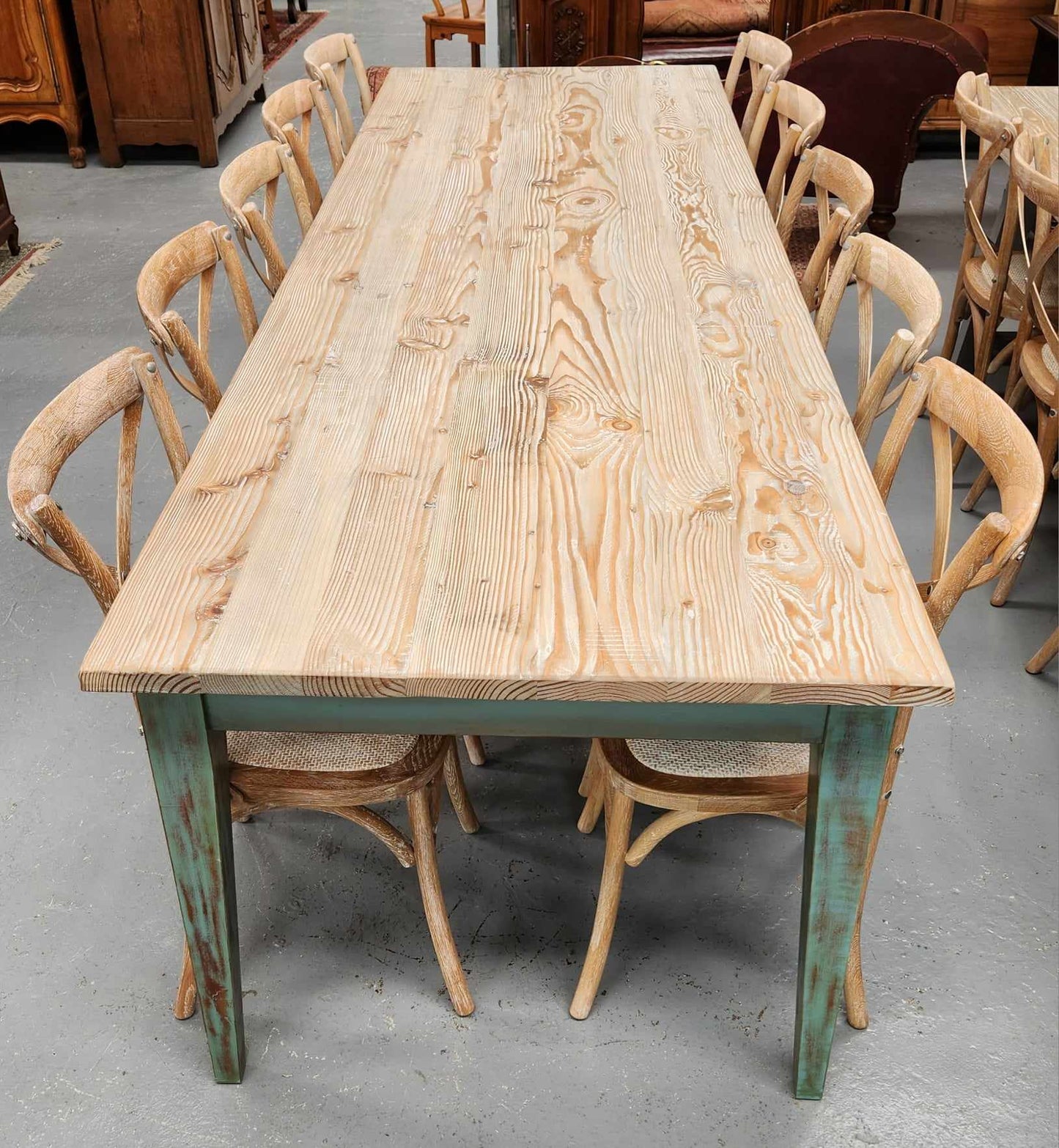 Bring the charm of rustic farmhouse style to your home with this handcrafted 3m Farmhouse style reclaimed Pine dining table. Seats 10 - 12 people. Material: Reclaimed Pine top and Reclaimed Pine base Colour: white washed and waxed natural timber top with Antique olive green base.