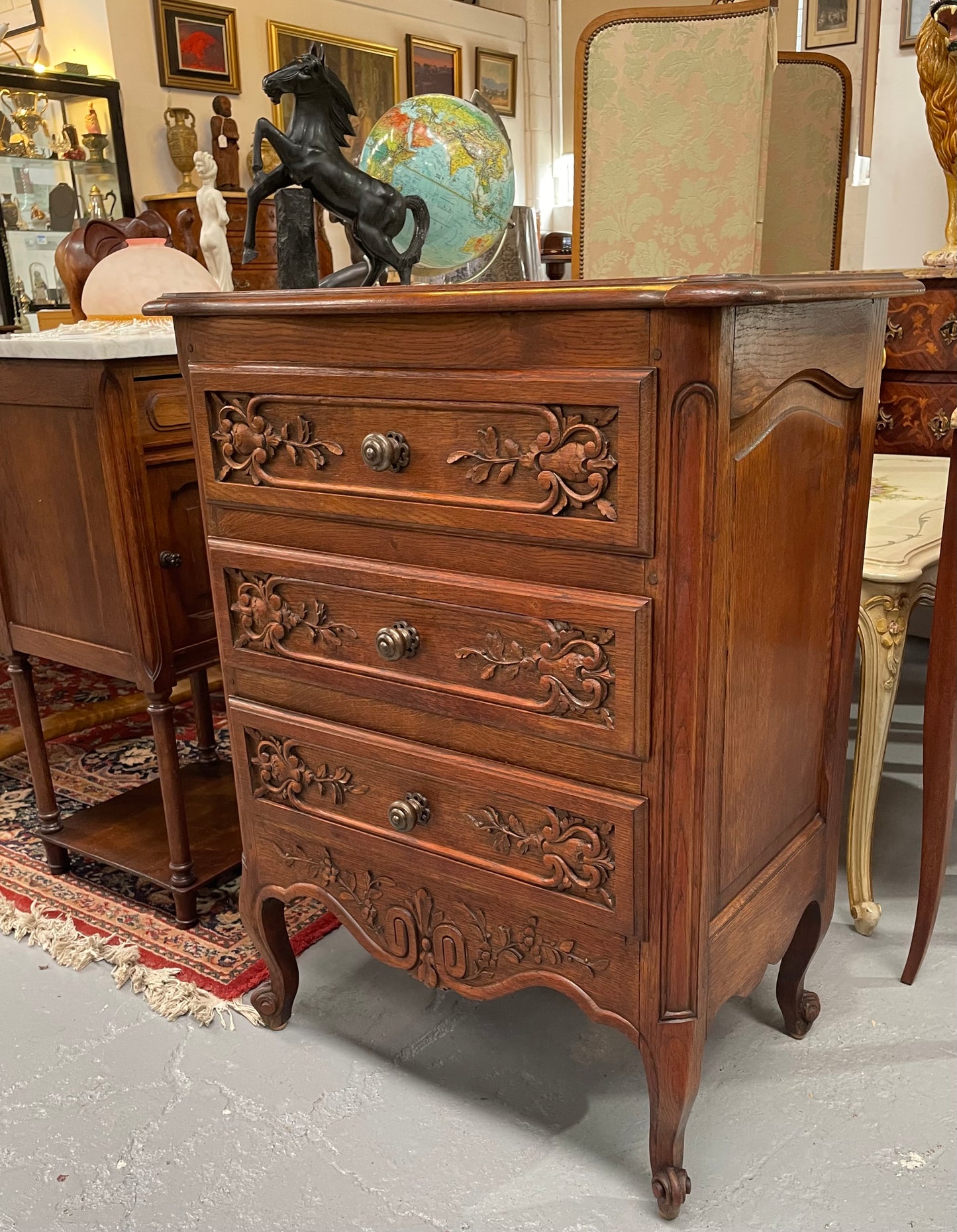 Beautiful French oak Louis XV style carved chest of three drawers with lovely details and in good original detailed condition. Sourced from France.