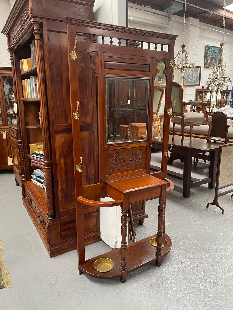 Lovely Edwardian walnut stand with six brass hooks and a storage box with lift up lid . Very nice carving to back and in good original condition. Please view photos as they help to form part of the description and condition. 