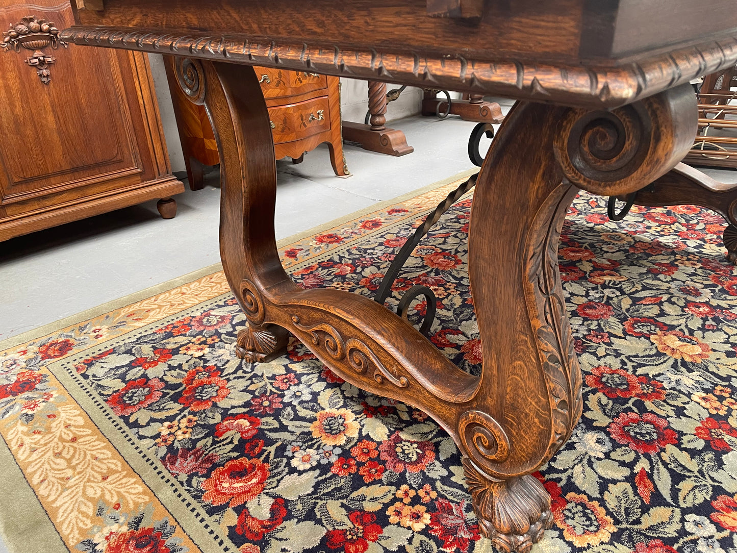 Beautiful French Oak Spanish style extension dining table with a decorative iron base and parquetry top. Lovely carvings on the legs and the skirt of the base. With the extensions closed it is 160 cm long and when fully extended it is 268 cm long. It has been sourced from France and in good original condition.