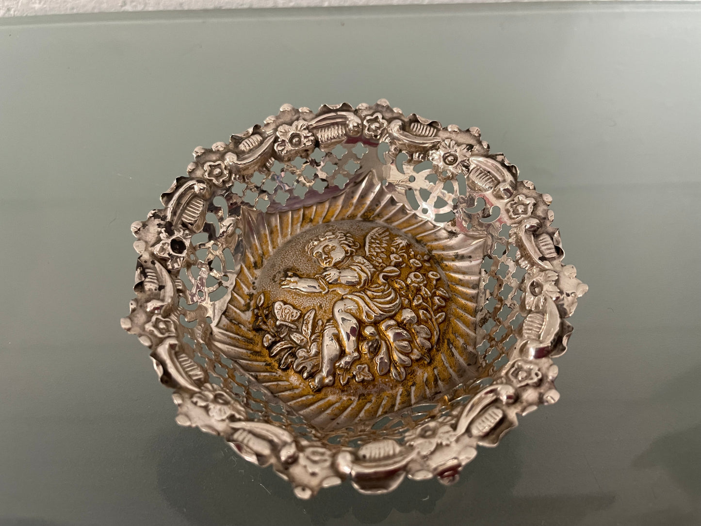 Lovely pair of sterling silver and silver gilt Edwardian bon bon dishes with decorative cherubs and in good original condition. Please see photos as they form part of the description.