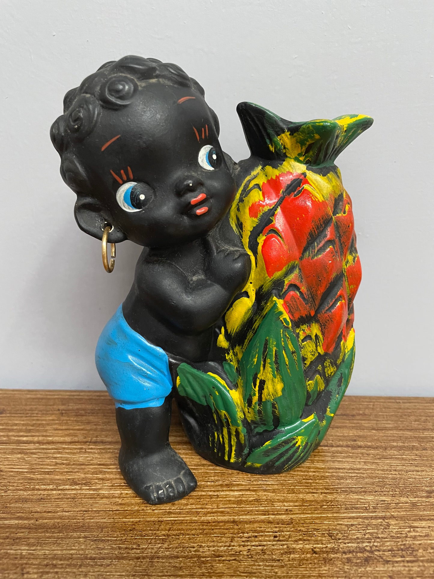 Japanese ceramic boy with pineapple money box.