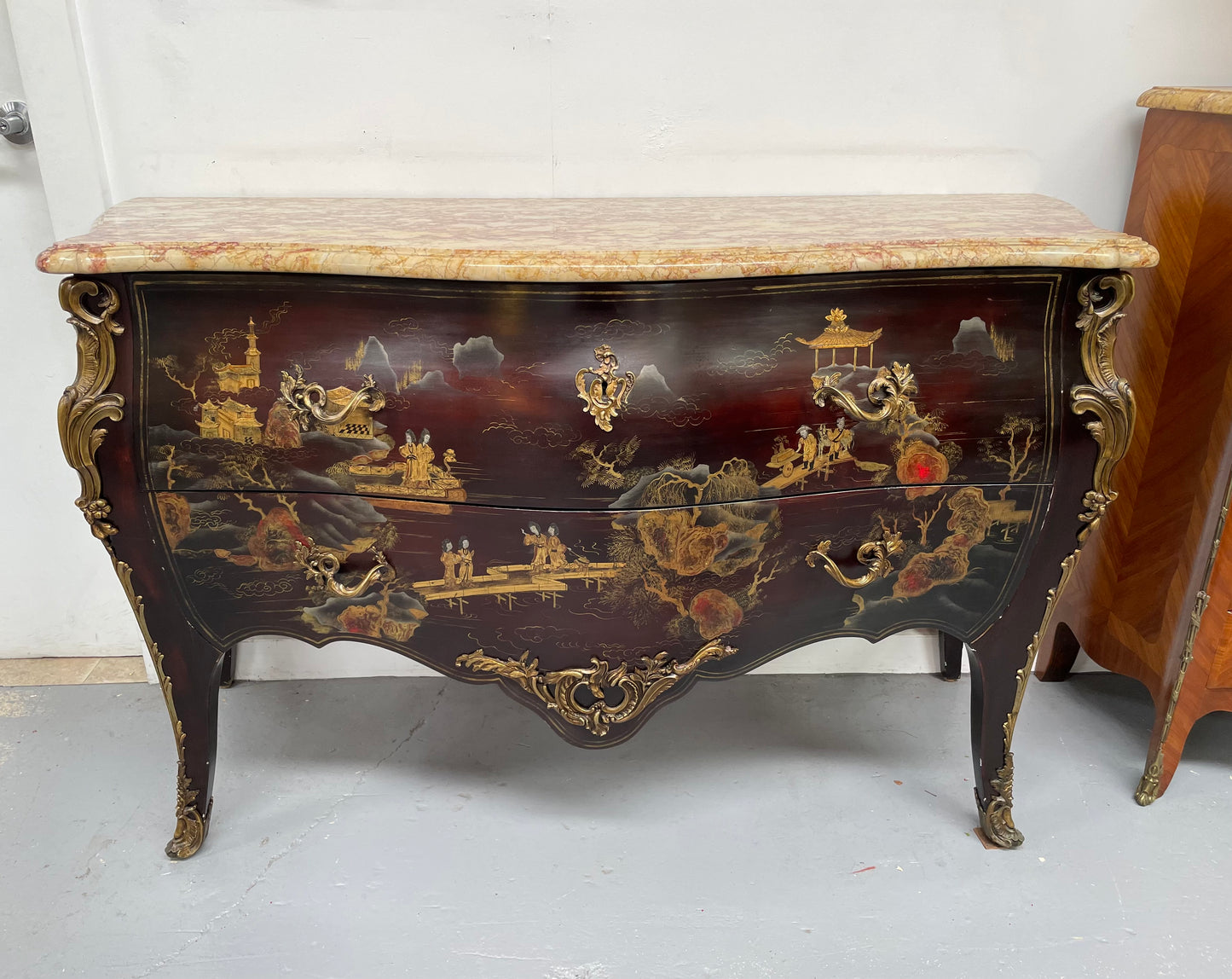 A stunning Antique Louis XV style Chinoiseries marble top two drawer commode with beautiful hand painted decorative details throughout. It has quality decorative ormolu mounts and handles. It is in good original detailed condition.