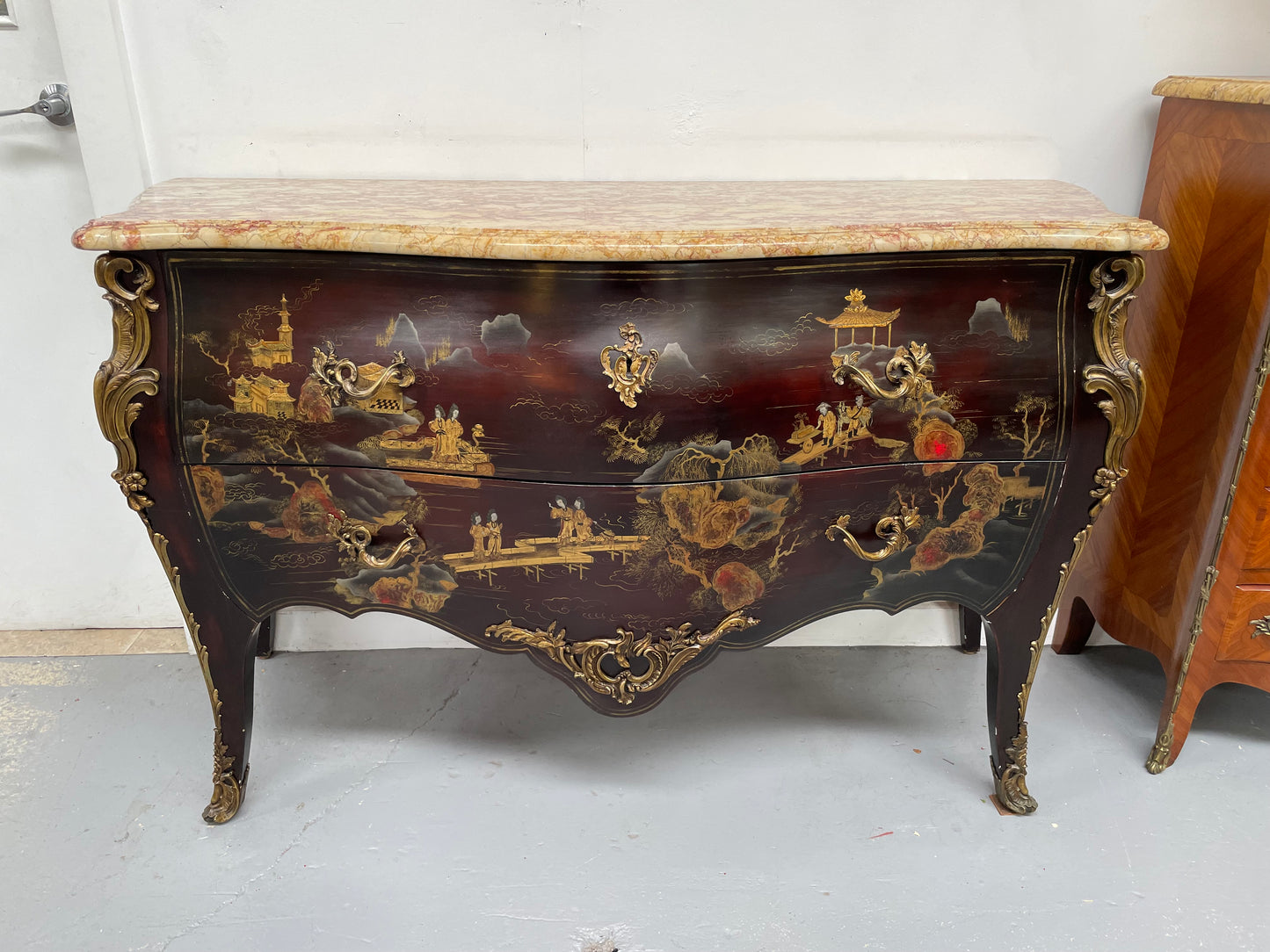 A stunning Antique Louis XV style Chinoiseries marble top two drawer commode with beautiful hand painted decorative details throughout. It has quality decorative ormolu mounts and handles. It is in good original detailed condition.