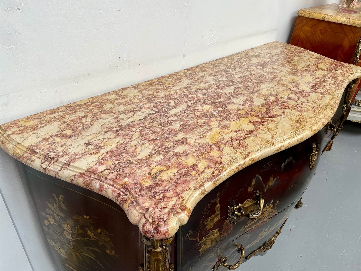 A stunning Antique Louis XV style Chinoiseries marble top two drawer commode with beautiful hand painted decorative details throughout. It has quality decorative ormolu mounts and handles. It is in good original detailed condition.