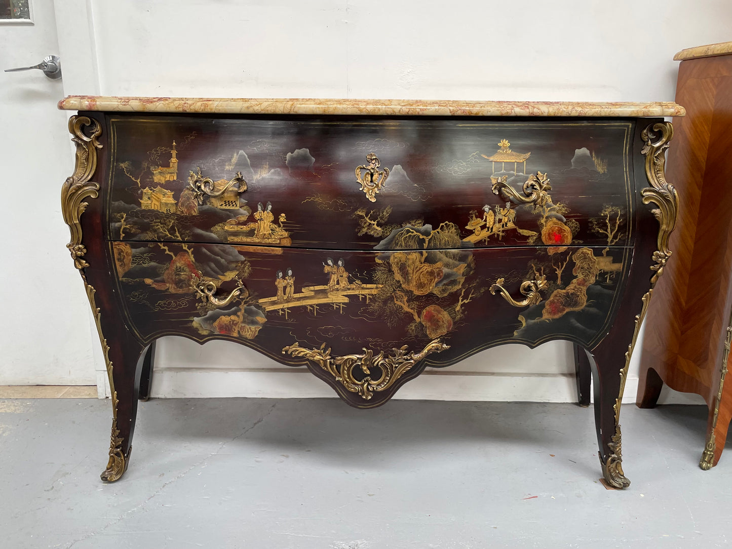 A stunning Antique Louis XV style Chinoiseries marble top two drawer commode with beautiful hand painted decorative details throughout. It has quality decorative ormolu mounts and handles. It is in good original detailed condition.