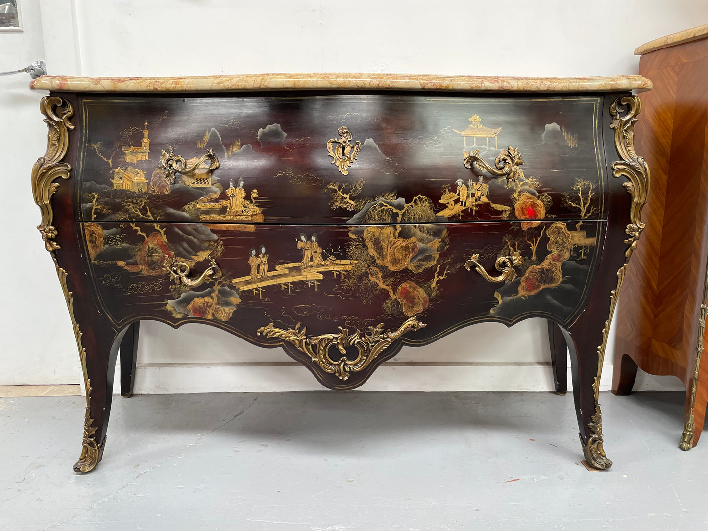 A stunning Antique Louis XV style Chinoiseries marble top two drawer commode with beautiful hand painted decorative details throughout. It has quality decorative ormolu mounts and handles. It is in good original detailed condition.