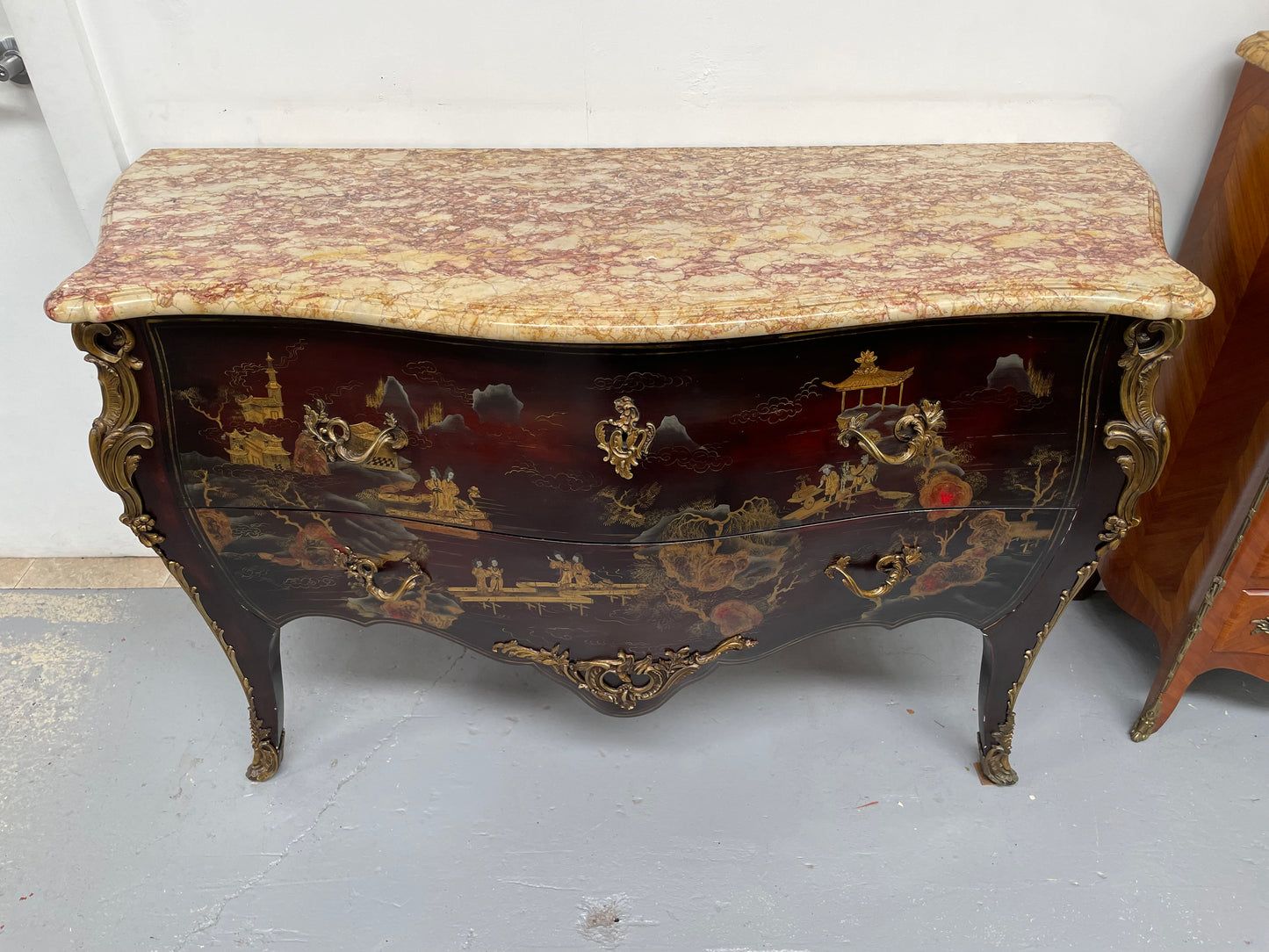 A stunning Antique Louis XV style Chinoiseries marble top two drawer commode with beautiful hand painted decorative details throughout. It has quality decorative ormolu mounts and handles. It is in good original detailed condition.