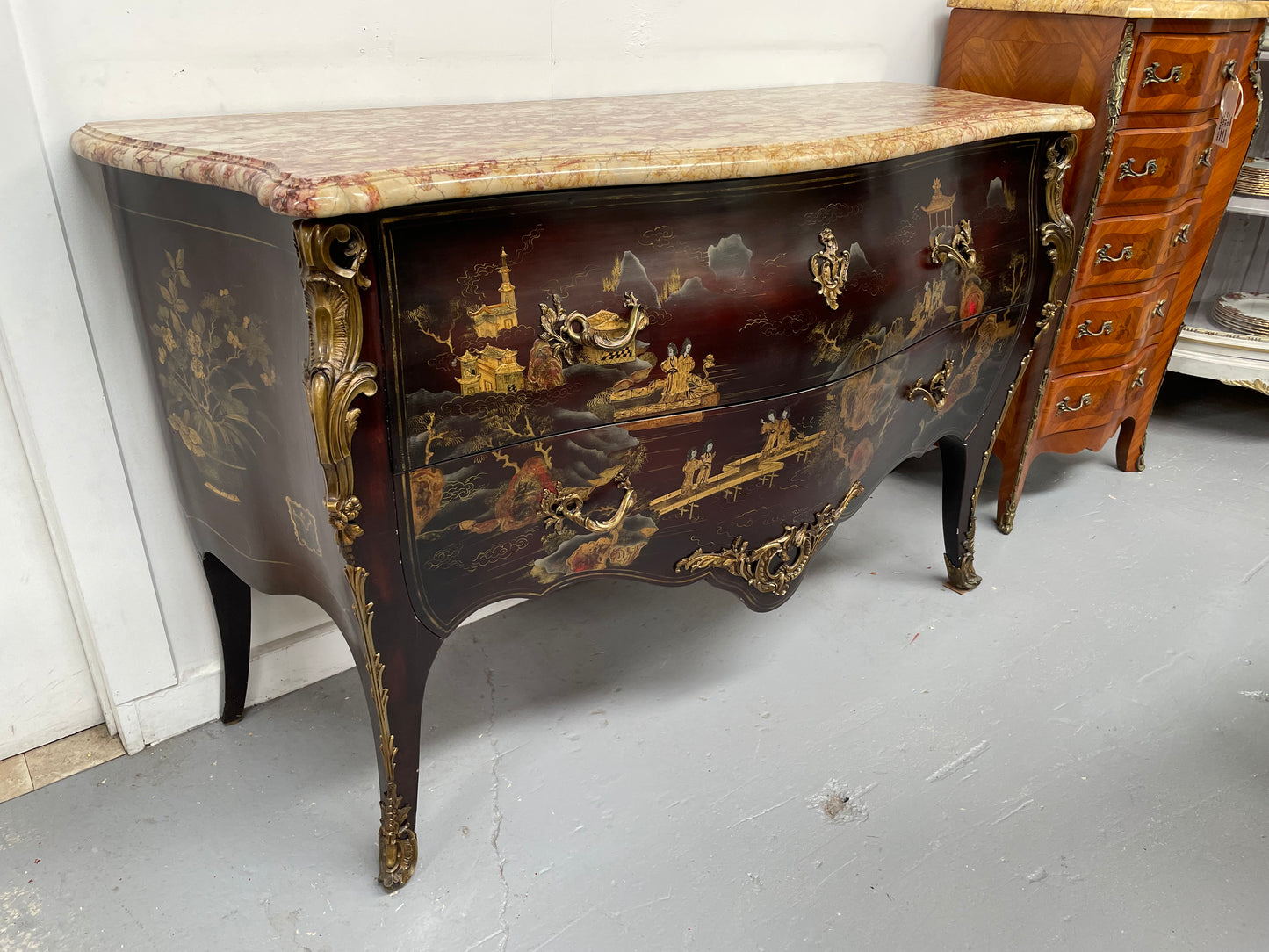 A stunning Antique Louis XV style Chinoiseries marble top two drawer commode with beautiful hand painted decorative details throughout. It has quality decorative ormolu mounts and handles. It is in good original detailed condition.