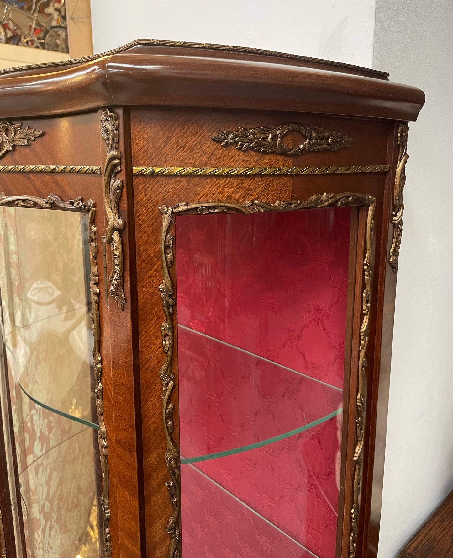 Beautiful French Louis XV style Walnut and bronze mounted vitrine with fabric interior and glass shelves. Sourced from France and in good original detailed condition.