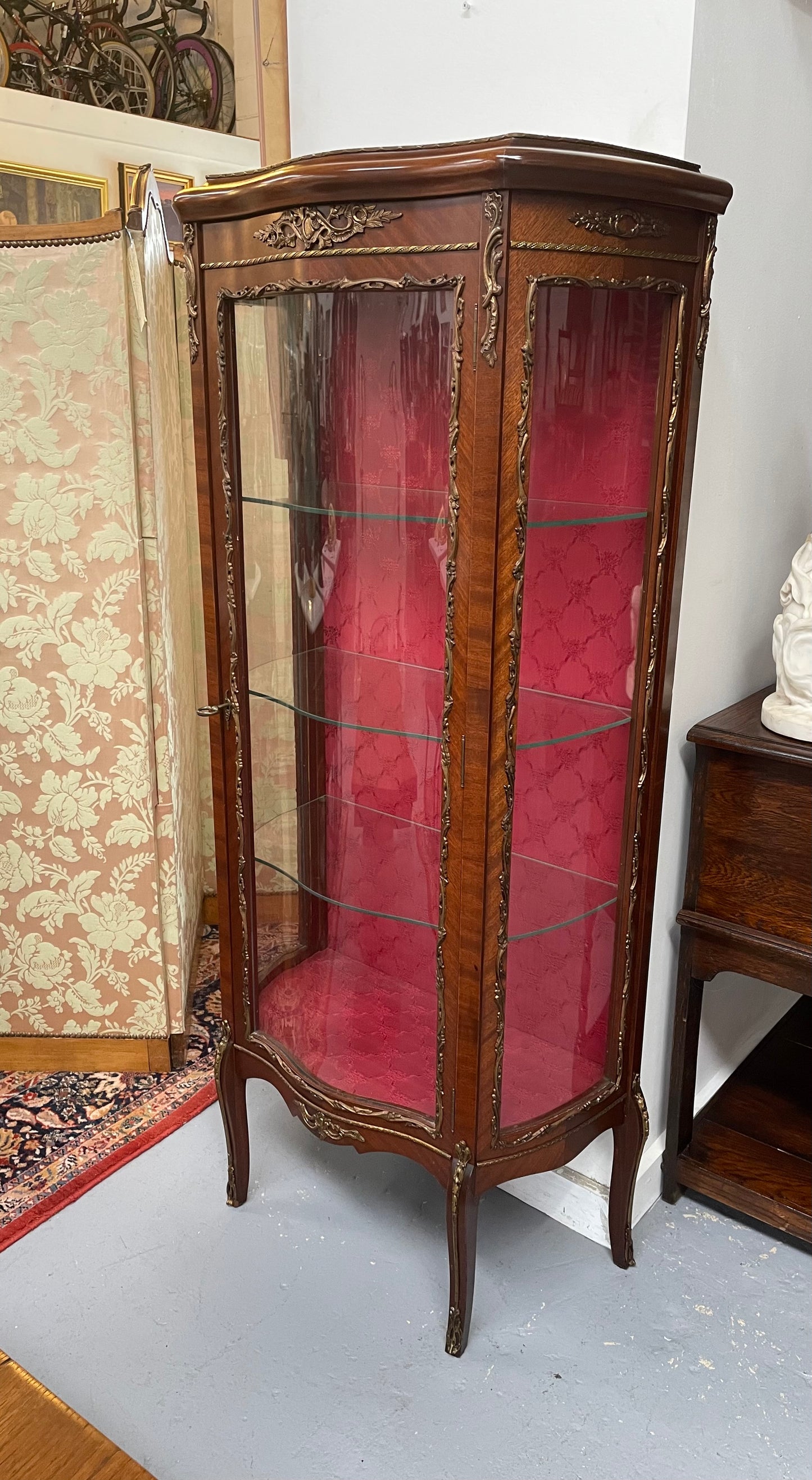 Beautiful French Louis XV style Walnut and bronze mounted vitrine with fabric interior and glass shelves. Sourced from France and in good original detailed condition.